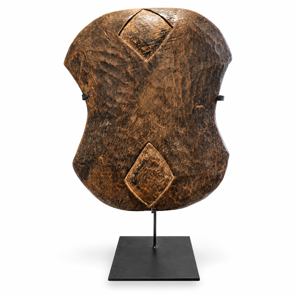 Brown wooden shield with diamond patterns on a white background on a display stand