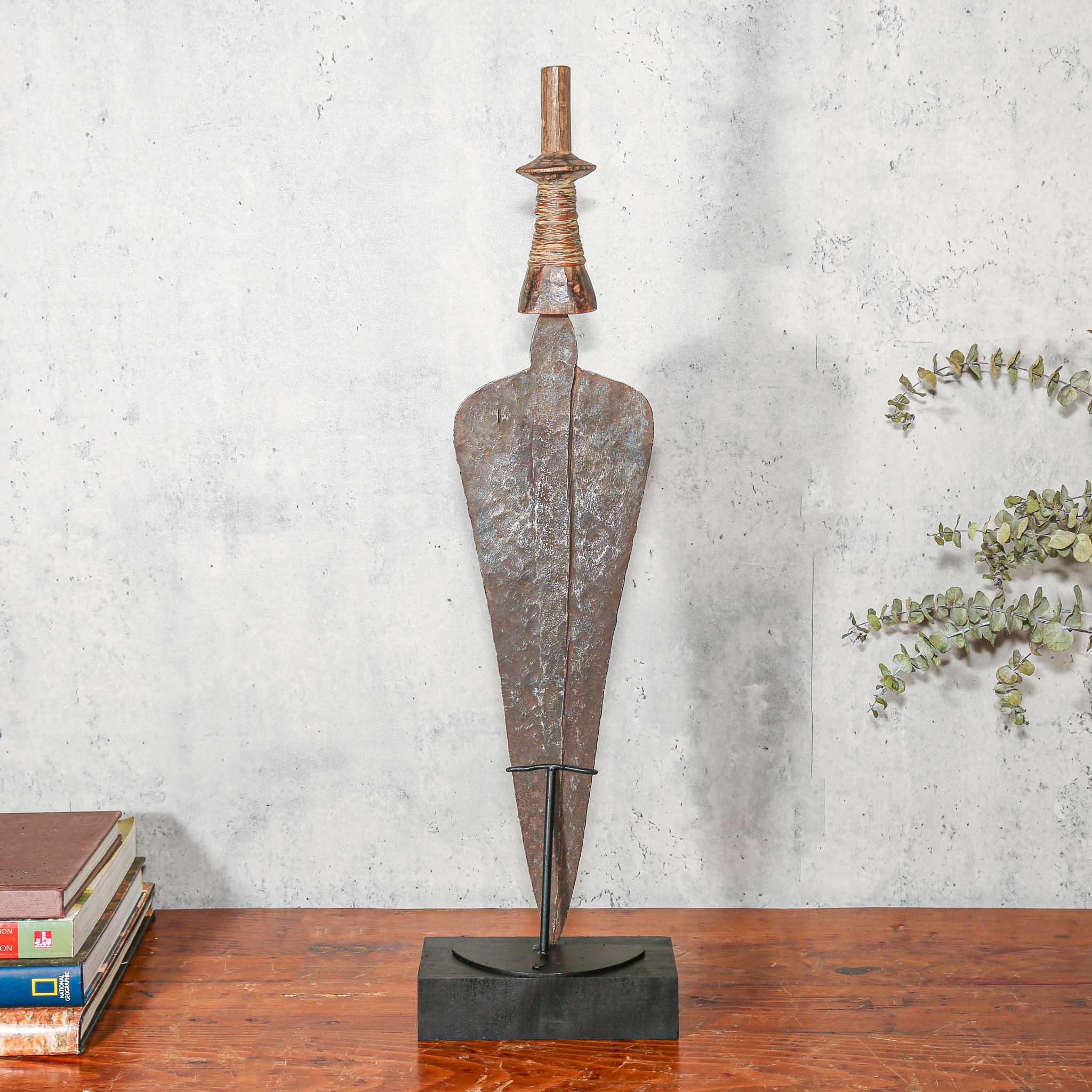Handmade Copper Kuba Currency Knife from D.R. Congo on a stand on a table