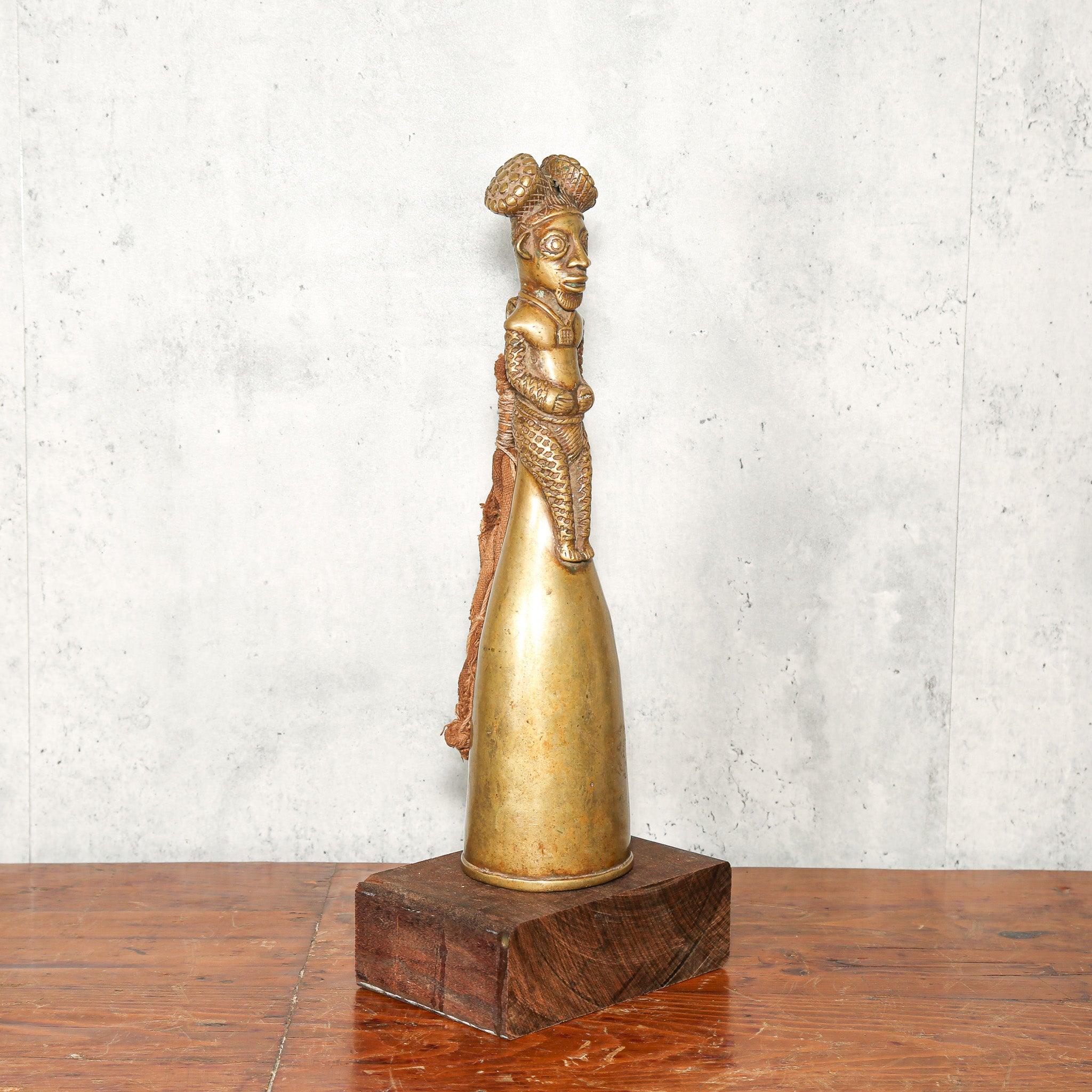 Bamum Brass Bell from Cameroon as a home decor idea standing on a table skewed to the left