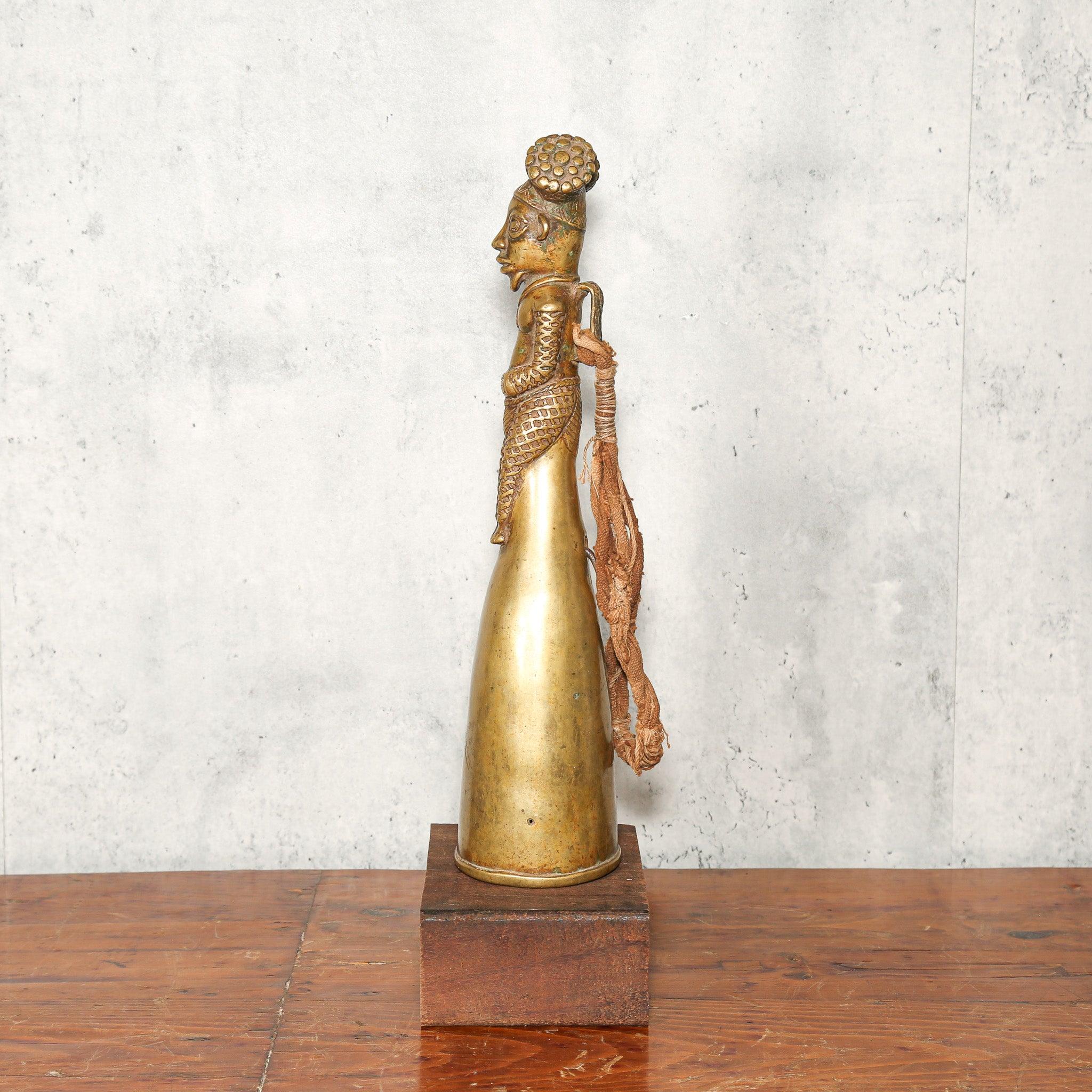 Bamum Brass Bell from Cameroon as a home decor idea standing on a table showing left side