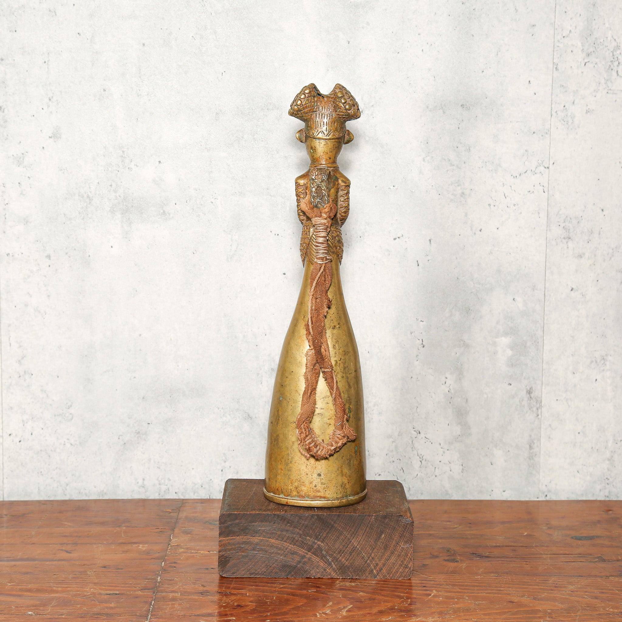 Bamum Brass Bell from Cameroon as a home decor idea standing on a table showing back side