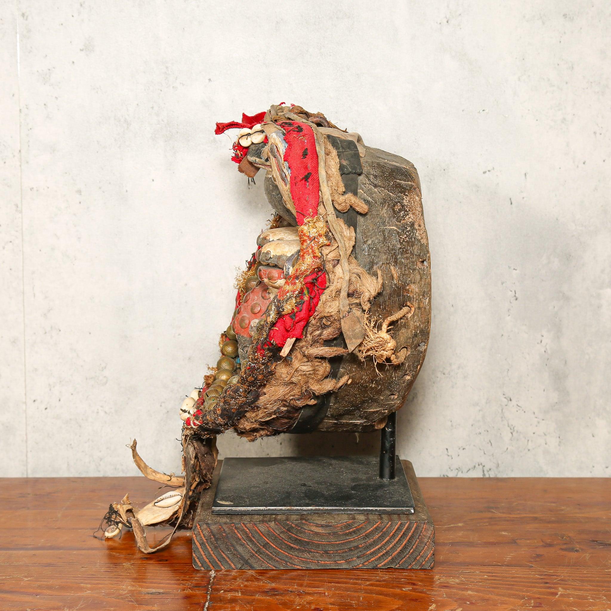 Dan Mask from Côte d’Ivoire as a home decor idea on a stand showing left side