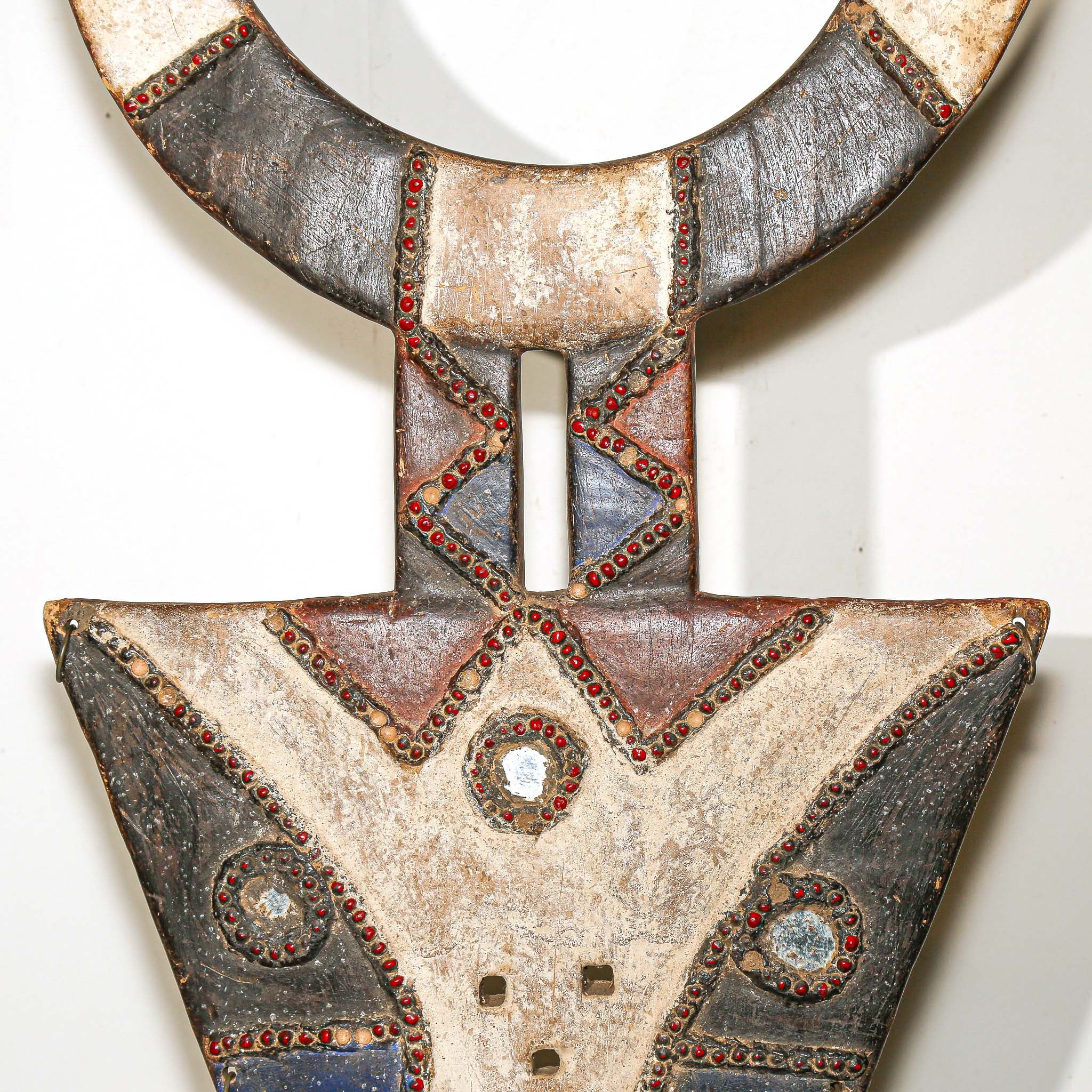 Bedu Plank Mask from Ivory Coast detail of red blue white and black carving
