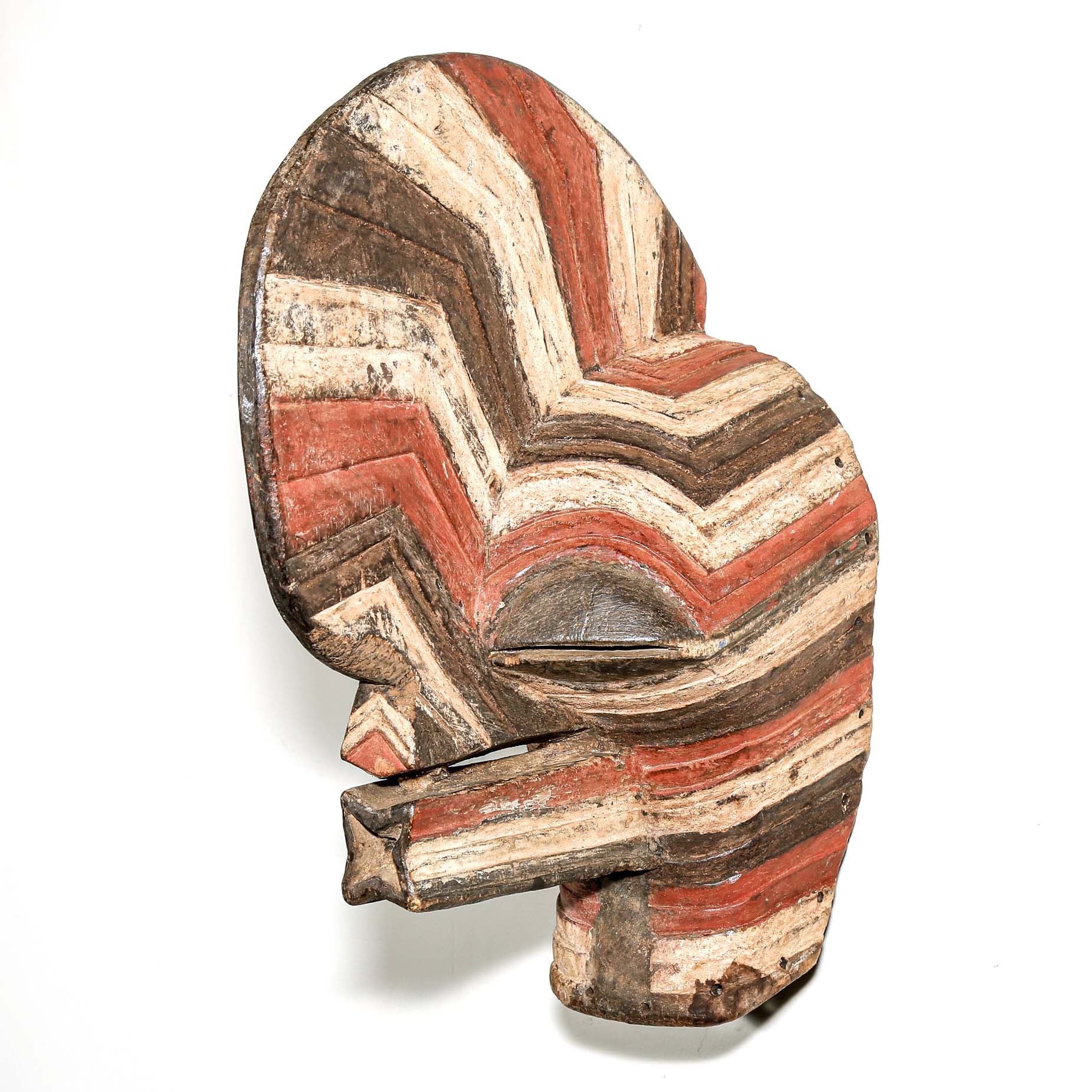 colorful Wooden African mask with striped pattern hanging on a white wall for sale