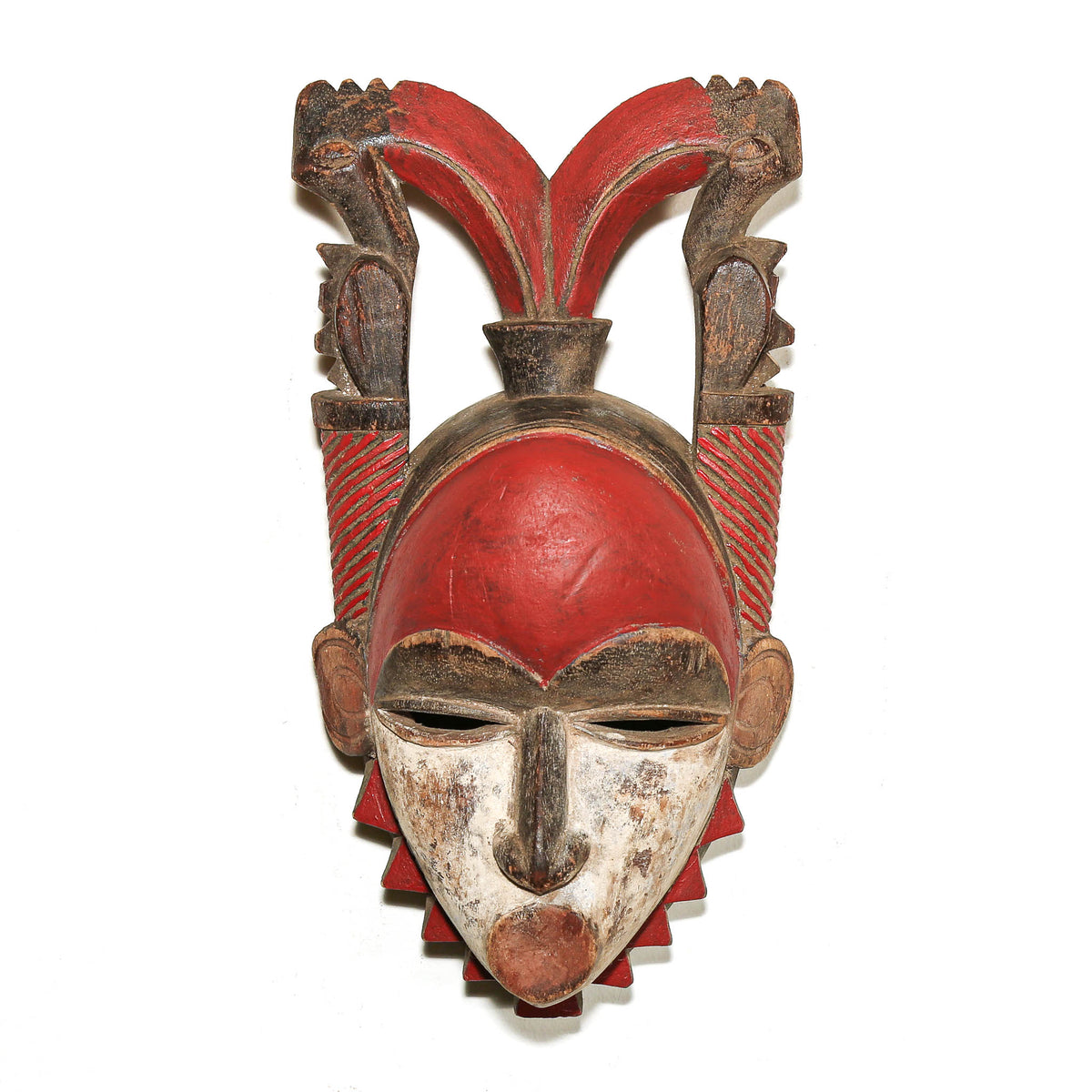 Red Baule mask from Ivory Coast with carved facial features and traditional West African design