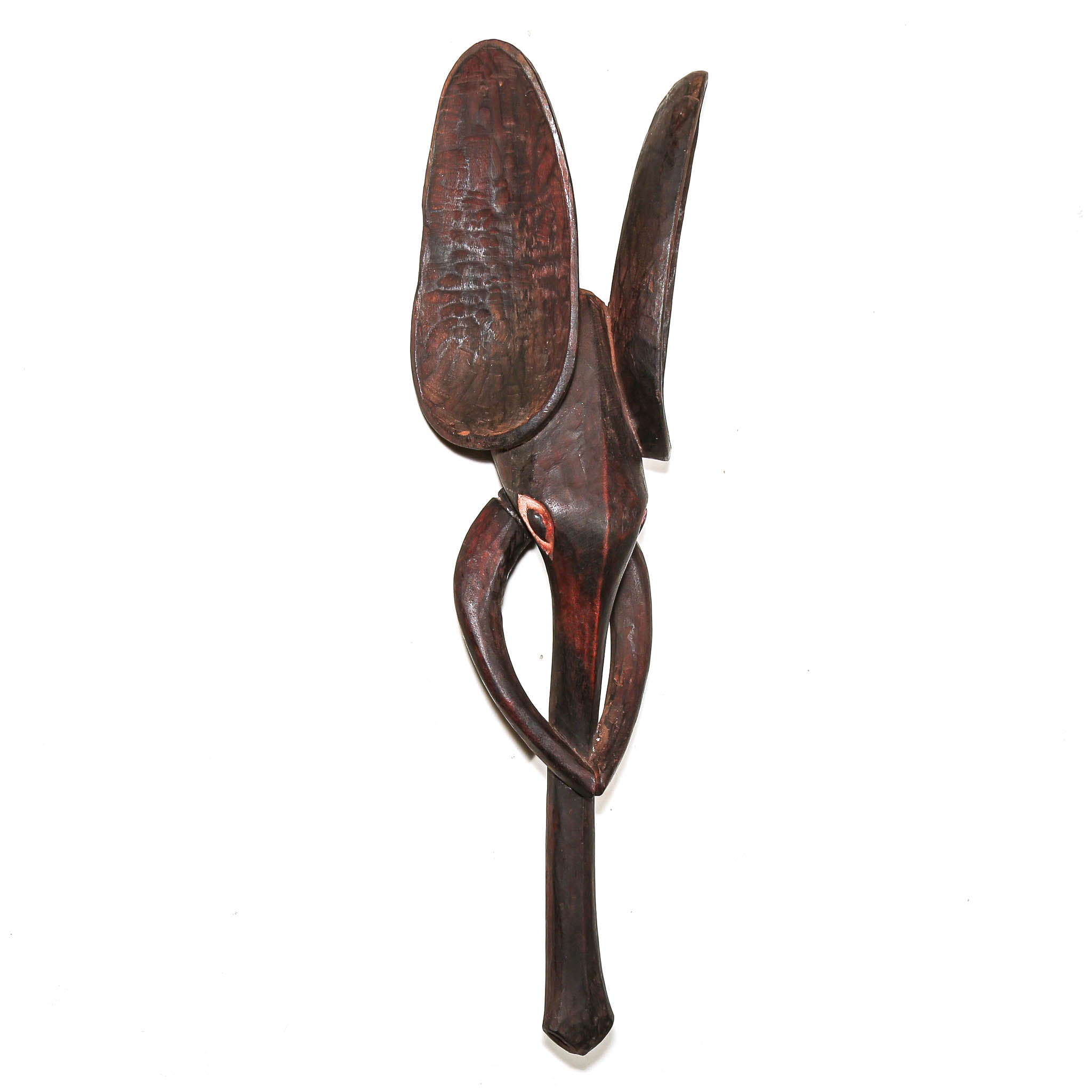 A dark brown carved wooden wall elephant art piece with organic, curved shapes and a small red accent, photographed against a solid white background.