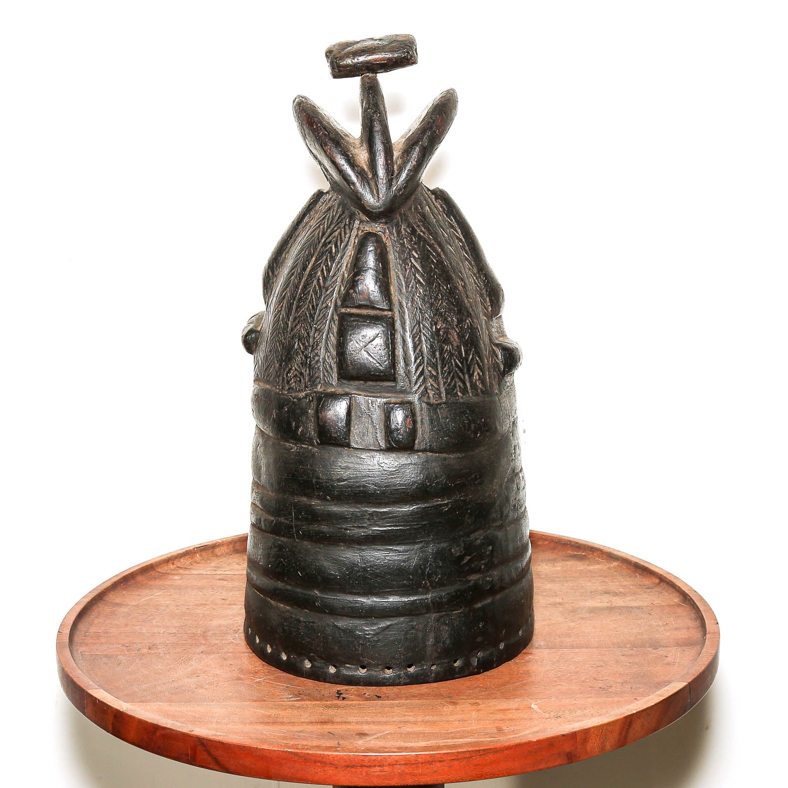 Black Mende Sande society helmet mask shown on a home side table