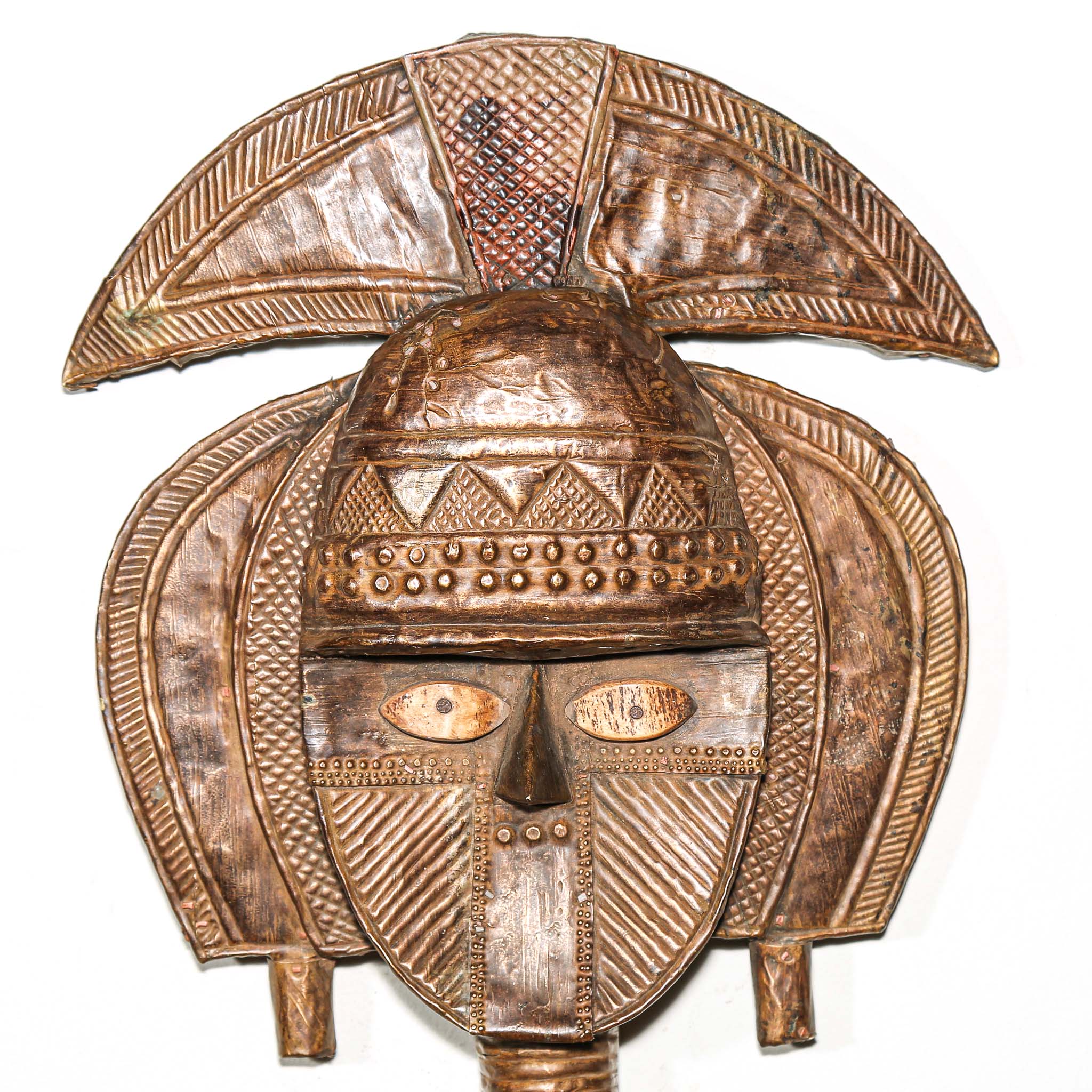 Close-up of copper and brass surface on antique Kota reliquary figure from Gabon