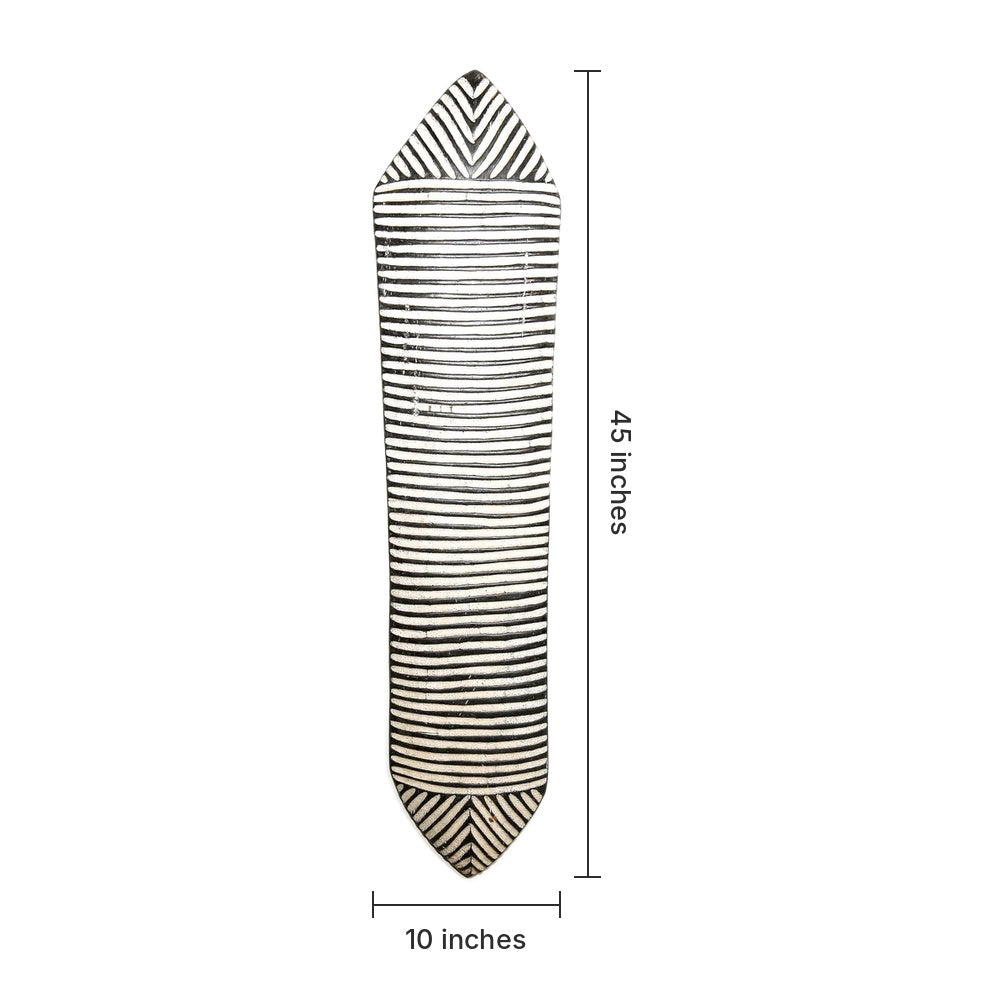 A long, narrow decorative wall hanging or shield-shaped piece with black and off-white horizontal stripes and chevron ends, shown on a white background with dimension labels indicating 45 inches tall and 10 inches wide.