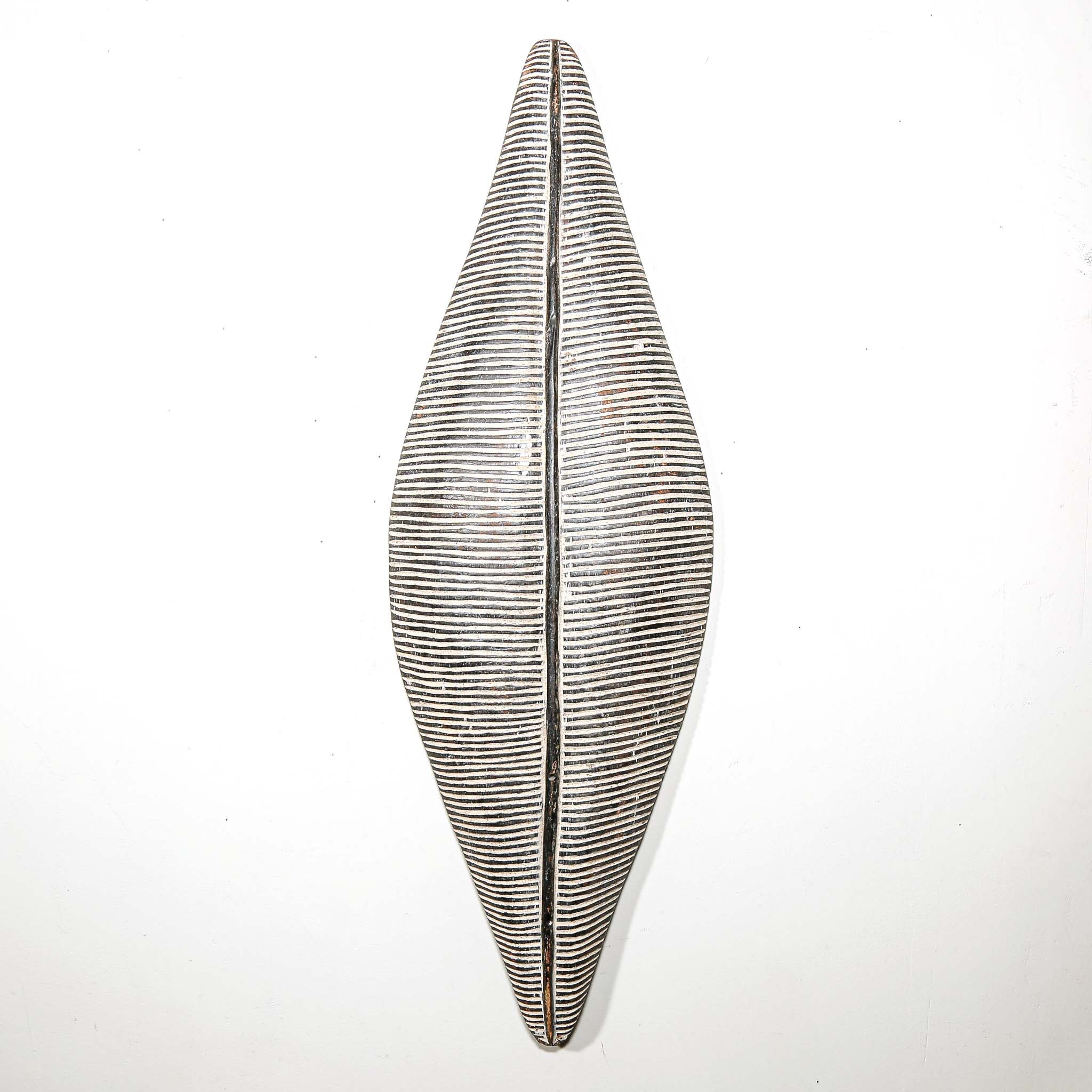 black and white wood African shield to hang on the wall for interior design ideas. Modern and tribal African art for sale.
