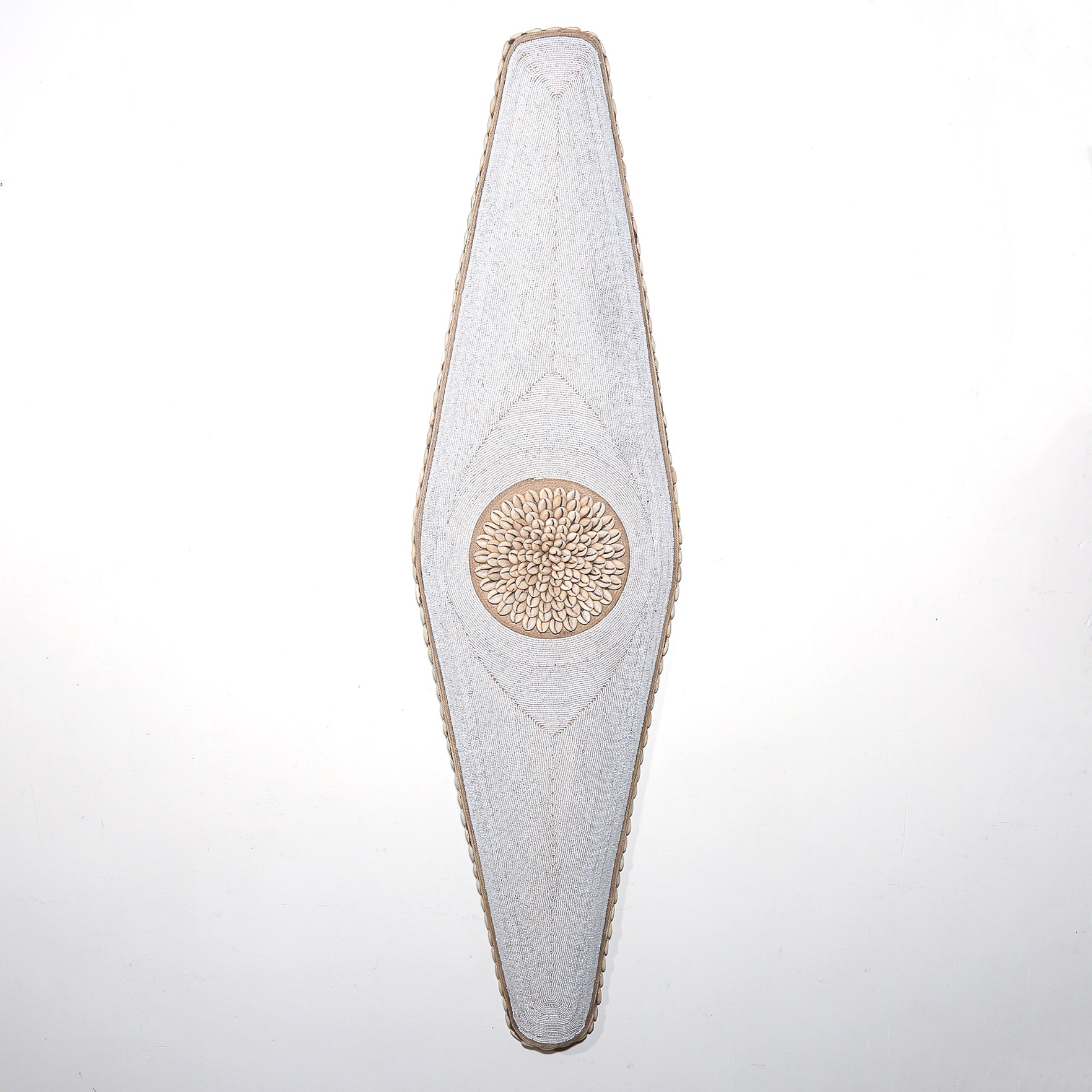 long white shield with white beads and cowrie shells from Cameroon. African Wall art for sale at Hemingway Gallery