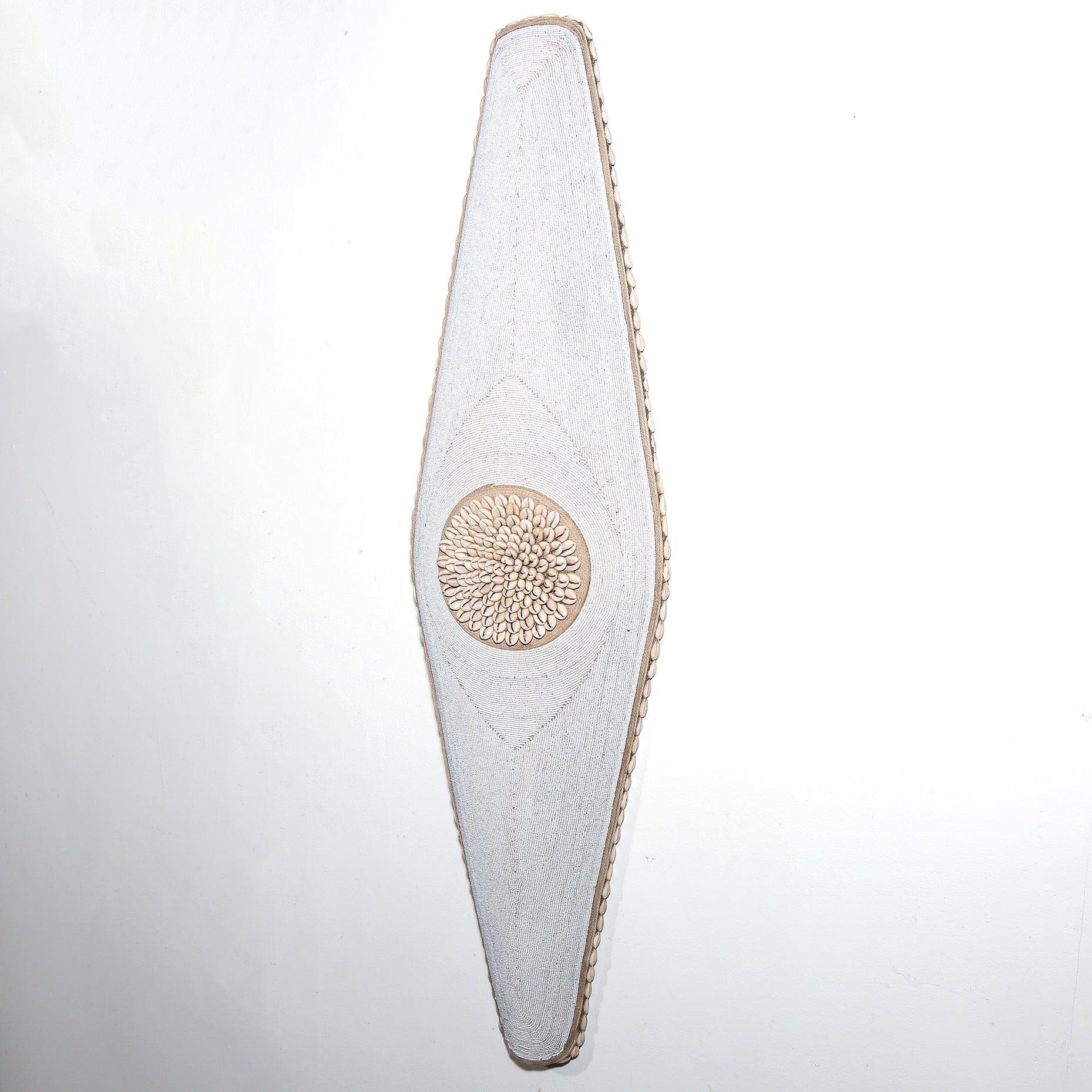 long white shield with white beads and cowrie shells from Cameroon. African Wall art for sale at Hemingway Gallery