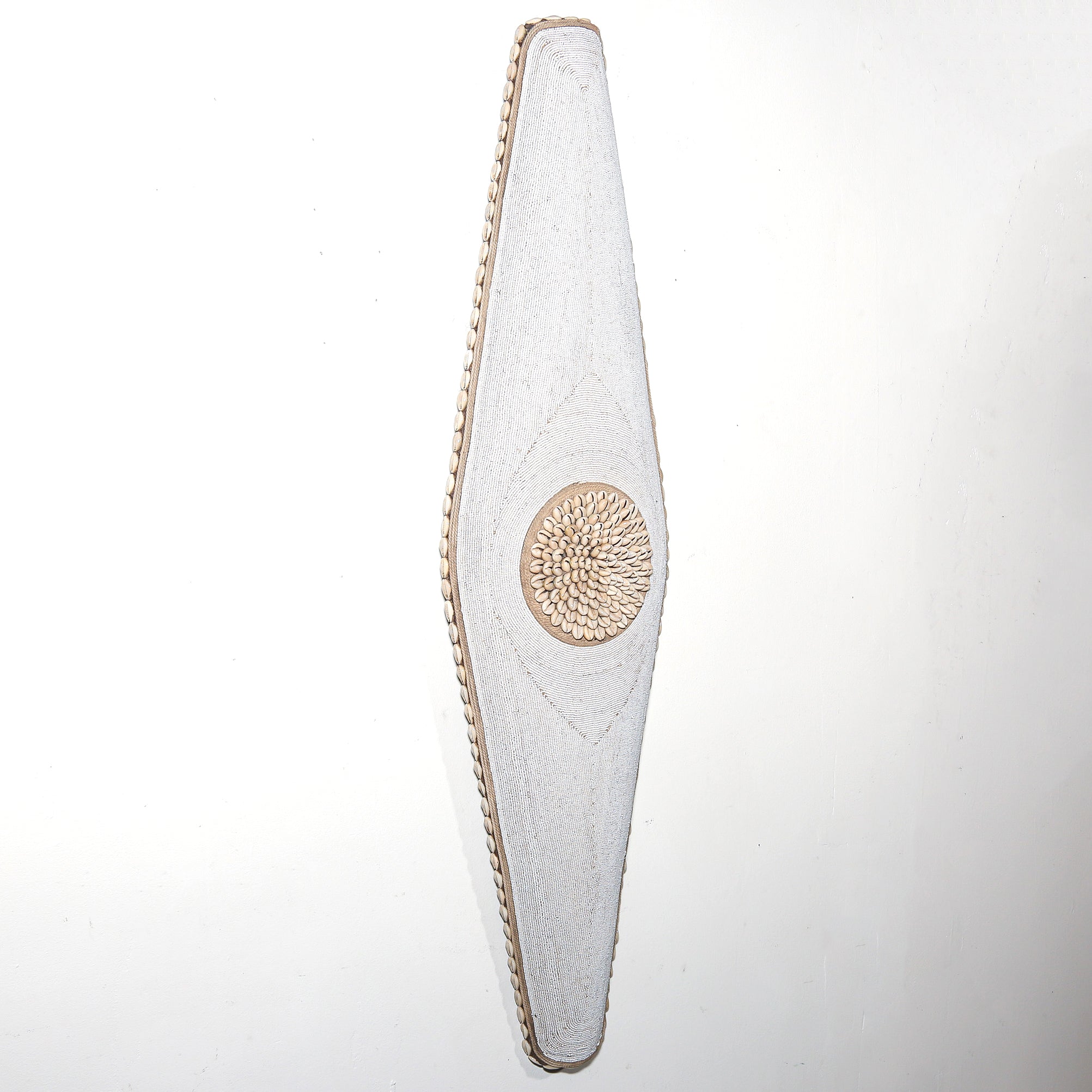 long white shield with white beads and cowrie shells from Cameroon. African Wall art for sale at Hemingway Gallery