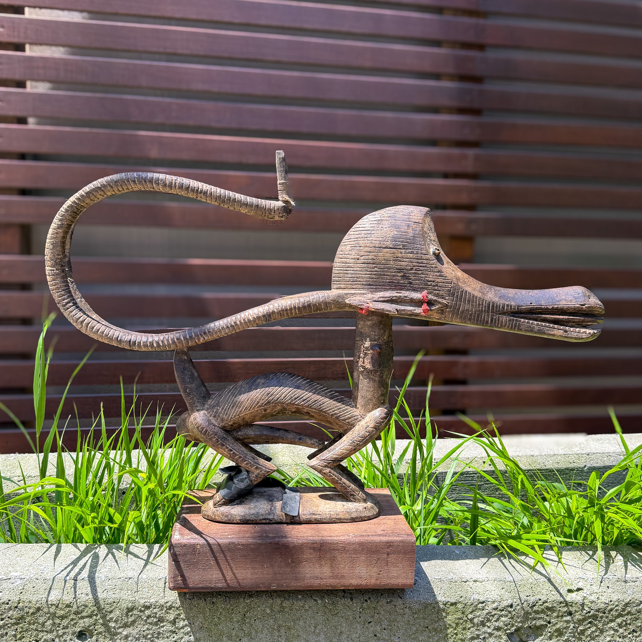 Chiwara antelope sculpture mounted on wooden display base