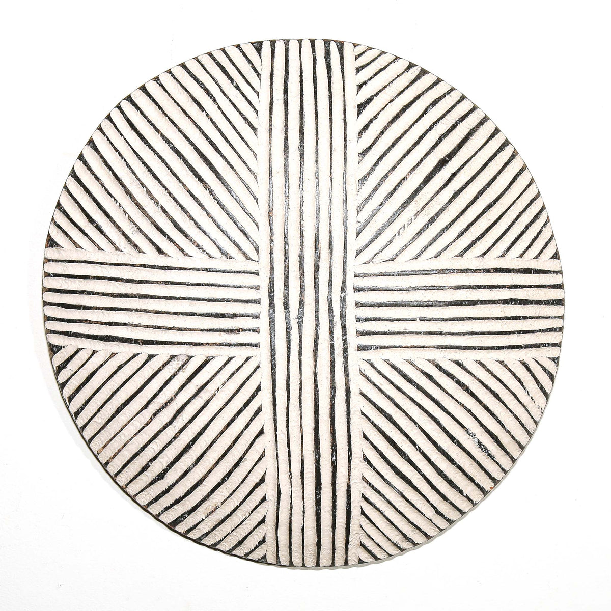 Round decorative wall shield from Cameroon with graphic surface details and a strong circular sculptural form