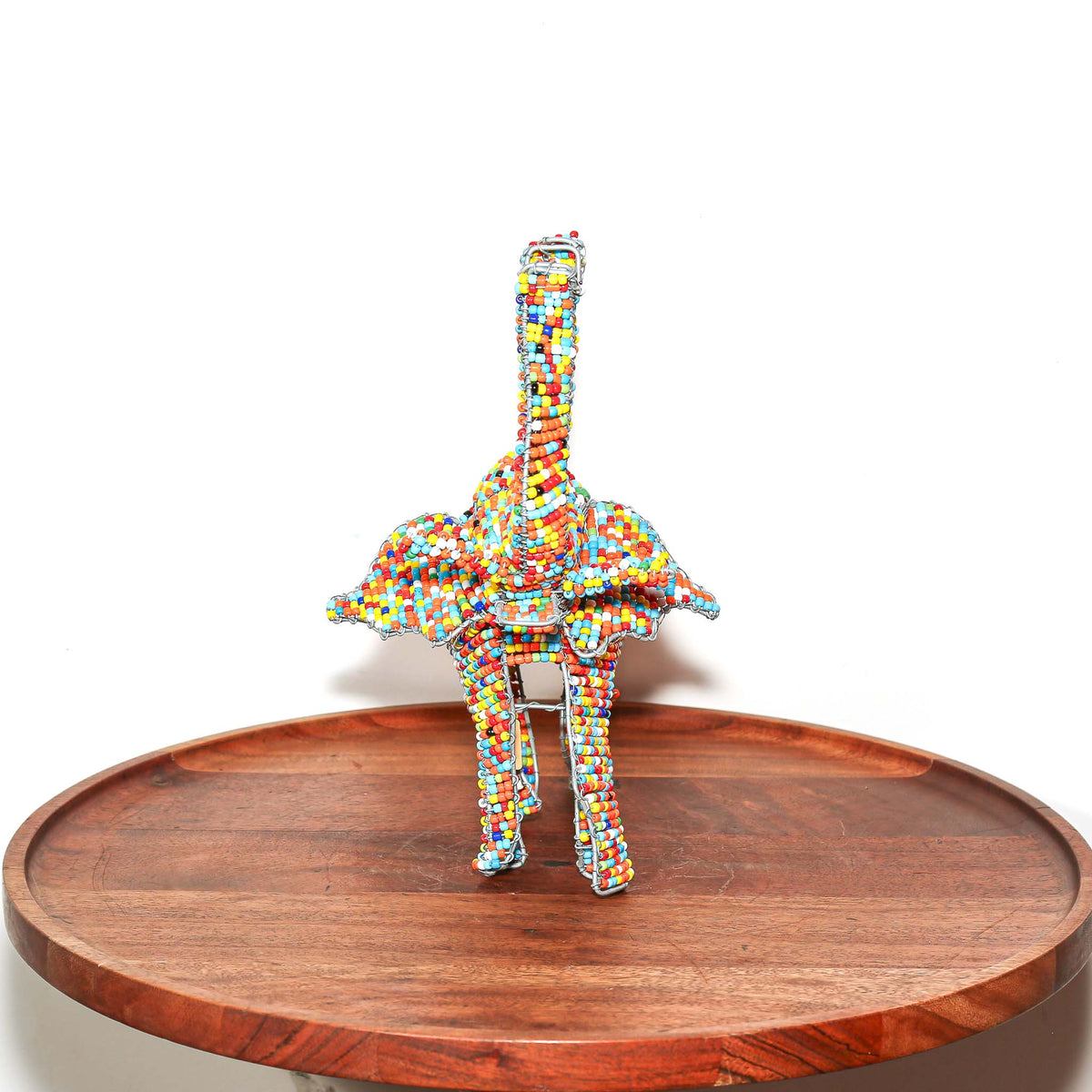 Decorative beaded elephant from South Africa with a colorful surface and sculptural wire frame for shelf or tabletop display