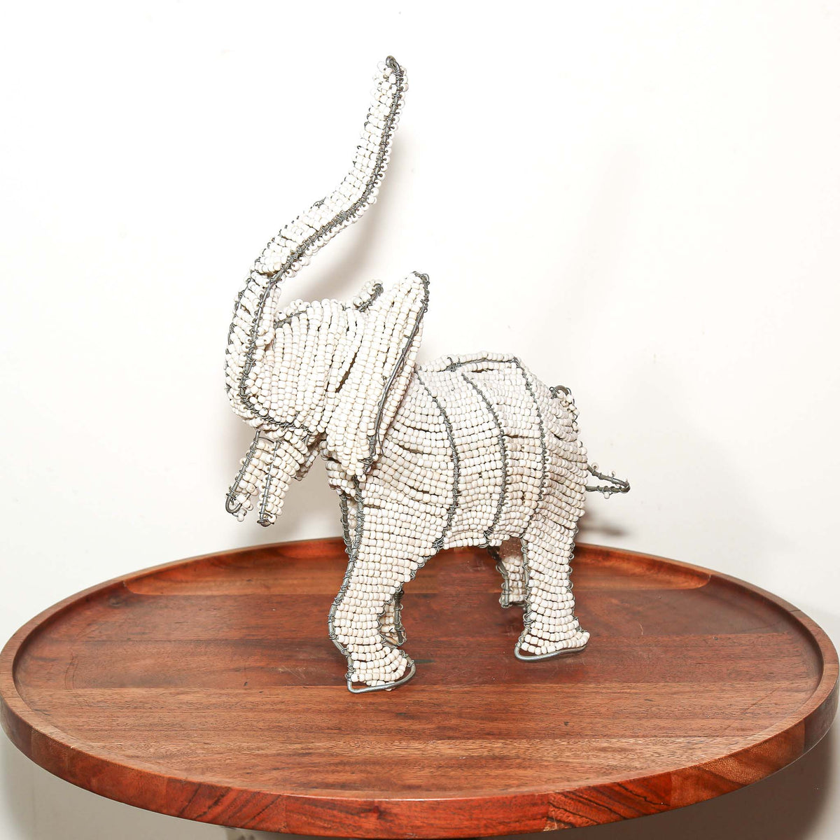 Handcrafted South African elephant figurine made from white beads and shaped wire with a refined sculptural form