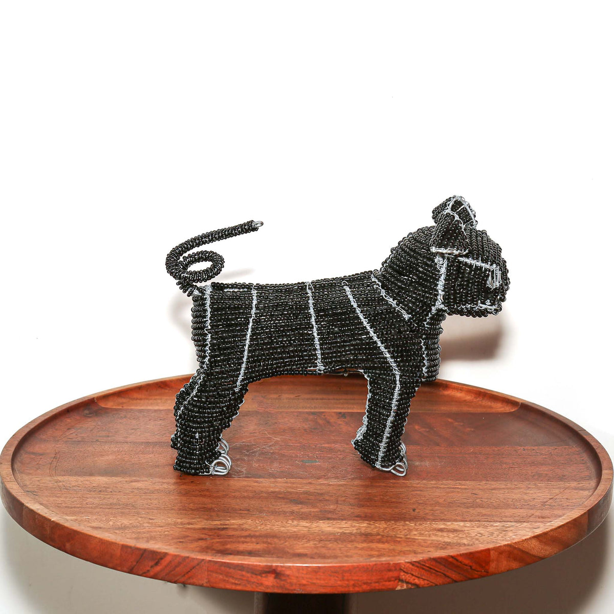 Handmade black beaded pug sculpture from South Africa with expressive form, artisan beadwork, and compact home decor appeal