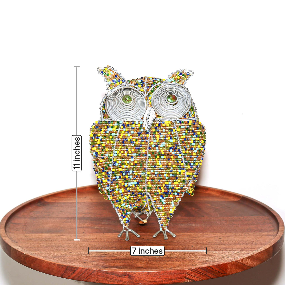 Small beaded owl sculpture featuring gold tones, vibrant accents, and detailed artisan craftsmanship from South Africa