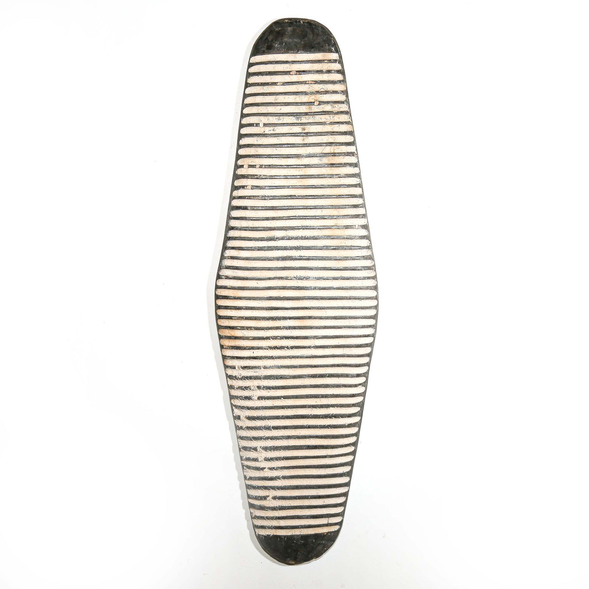Black and white decorative wall-hanging shield from Cameroon with bold geometric patterns and sculptural African design