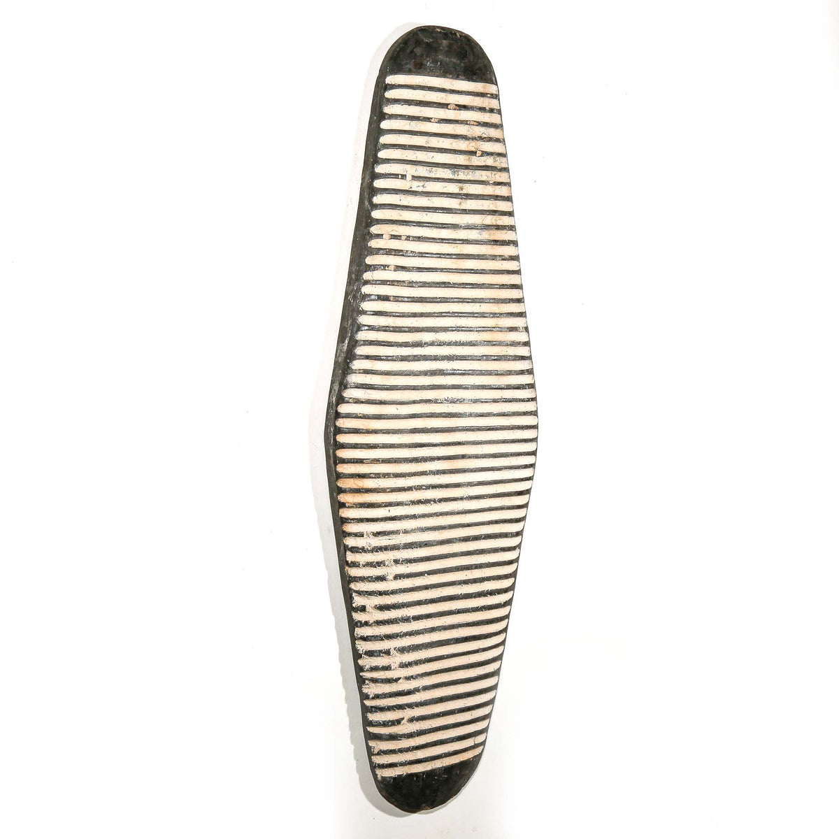 Handcrafted Cameroon decorative shield featuring contrasting black and white surface patterns for wall display