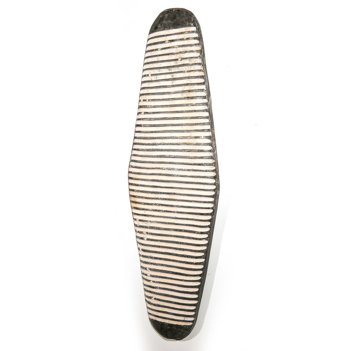 African wall decor shield from Cameroon with graphic black and white detailing and a strong sculptural presence