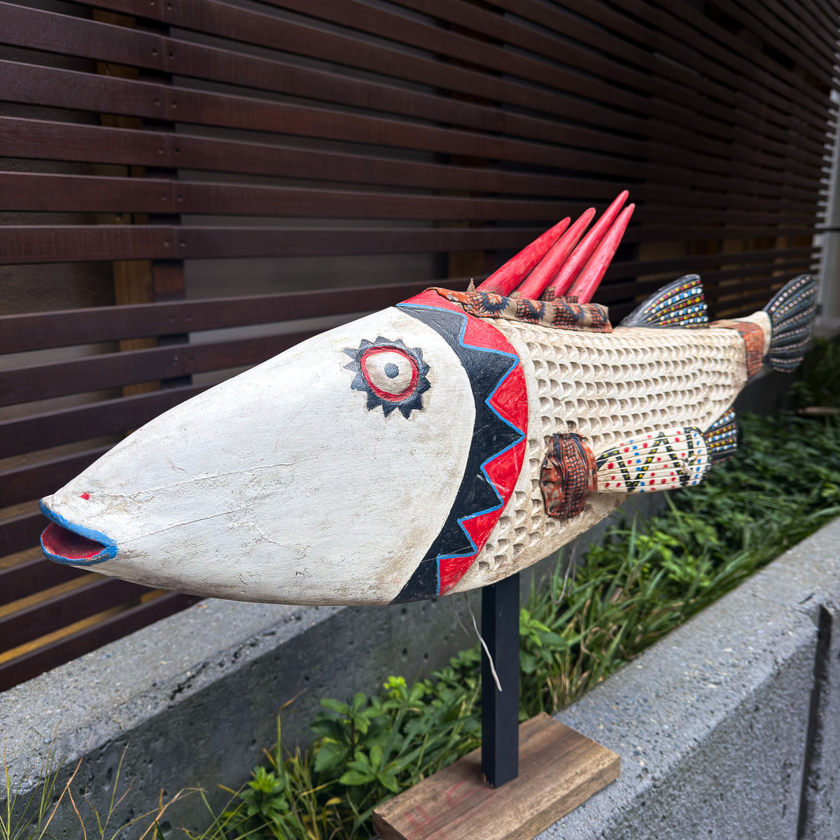 Oversized white fish puppet sculpture featuring a long sculptural body and distinctive hand-crafted details