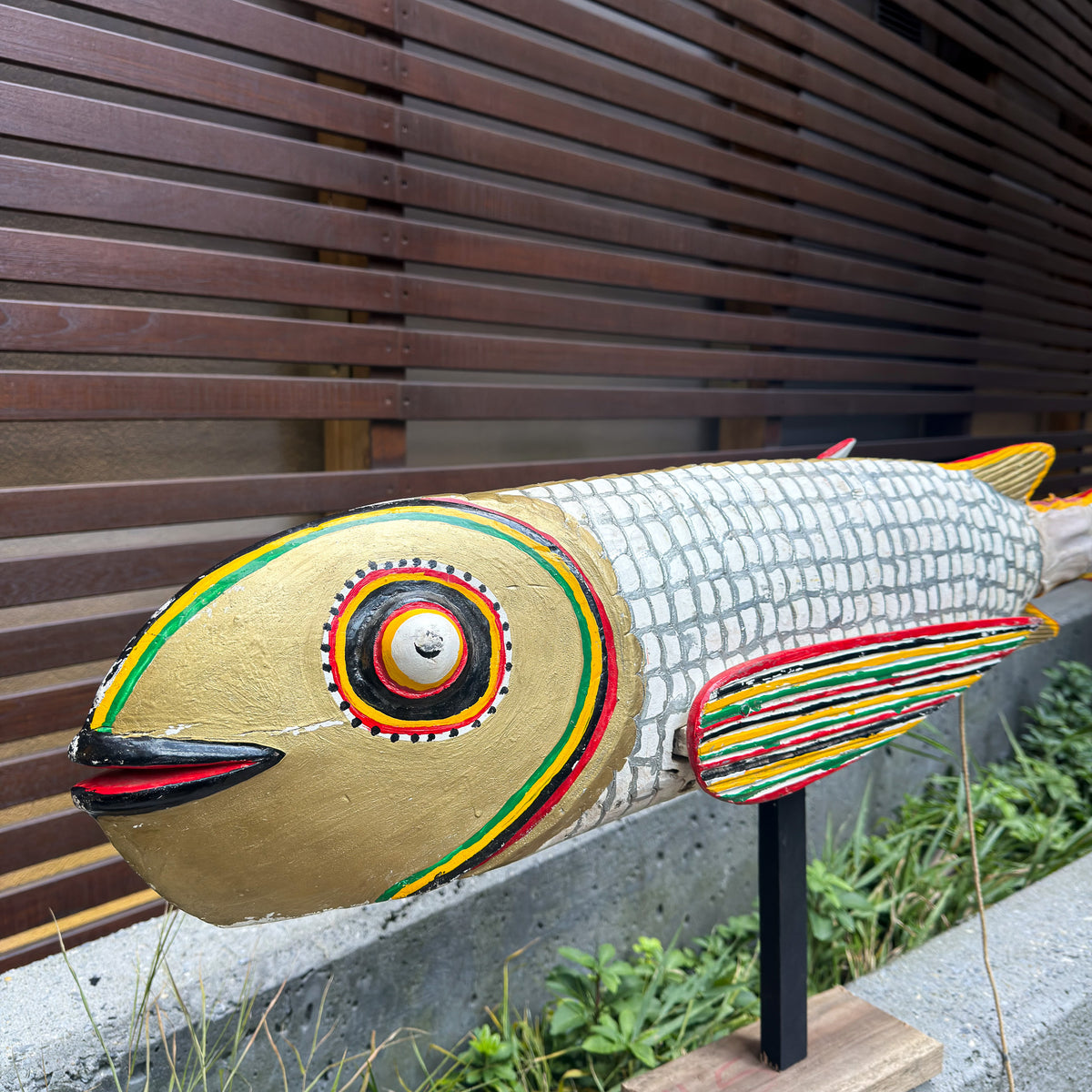 Large decorative fish sculpture in white with movable puppet-style construction and an expressive carved form