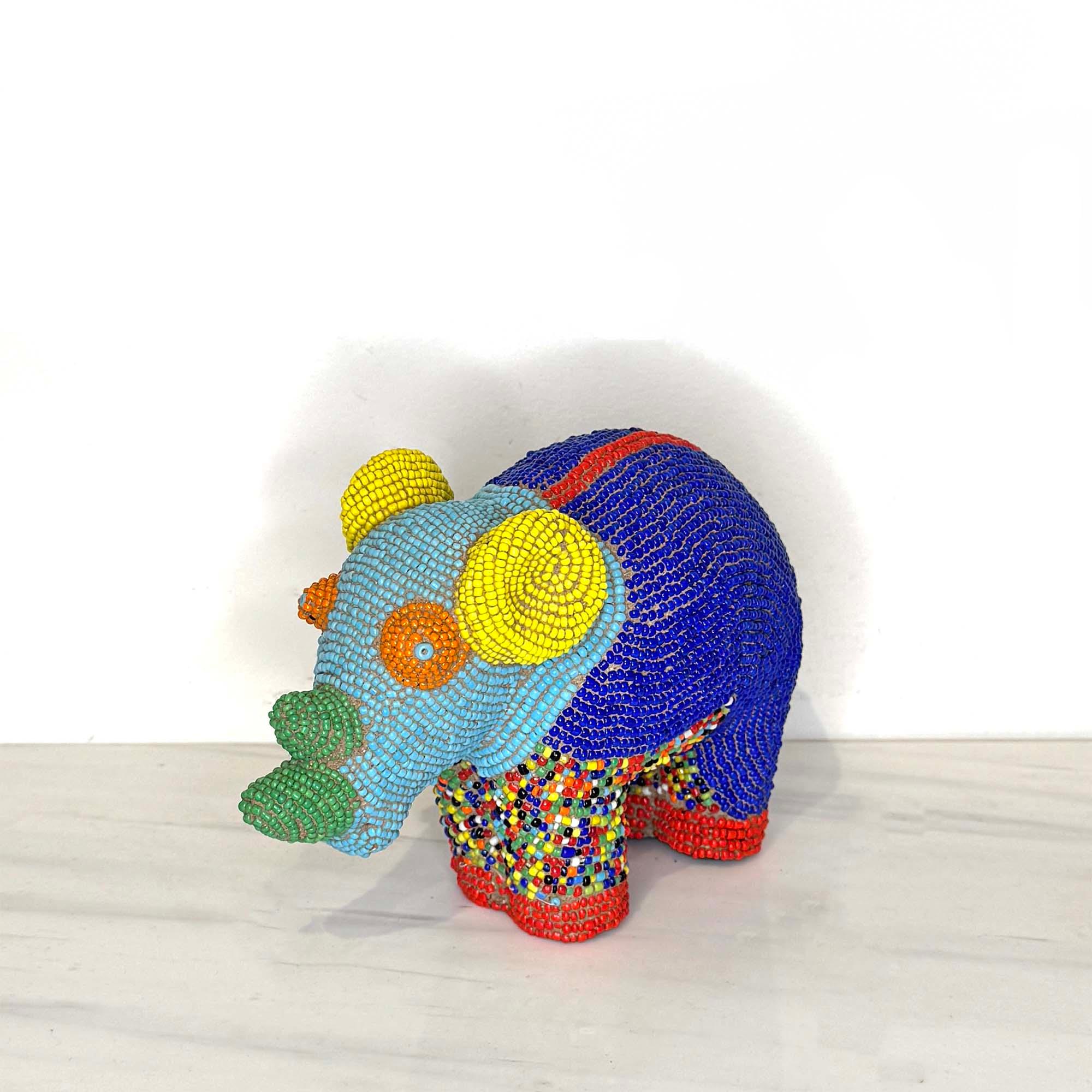Beaded Terracotta Bamileke Rhino Sculpture from Cameroon - Small on a table