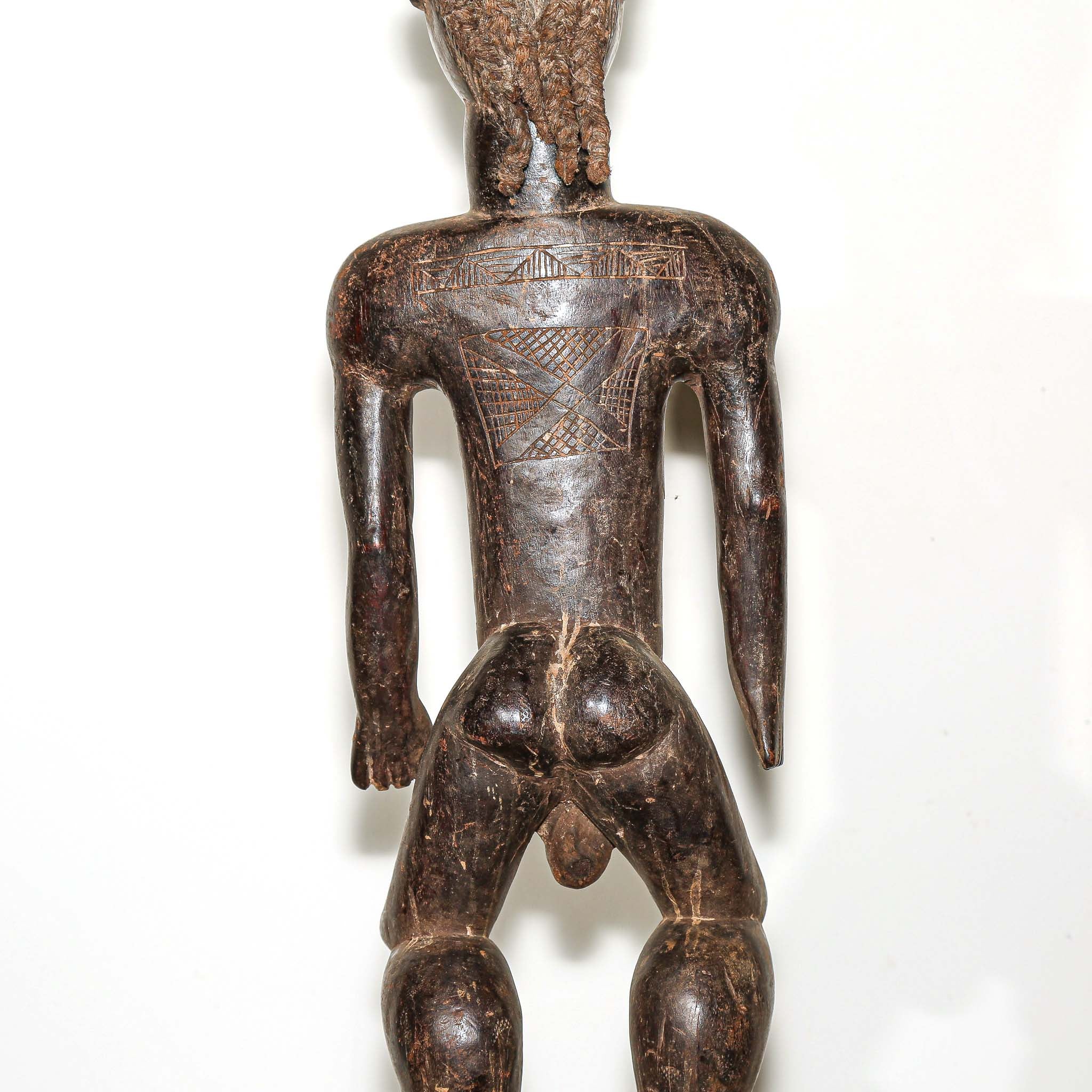 wooden male figure sculpture carved by the Dan people in Ivory Coast