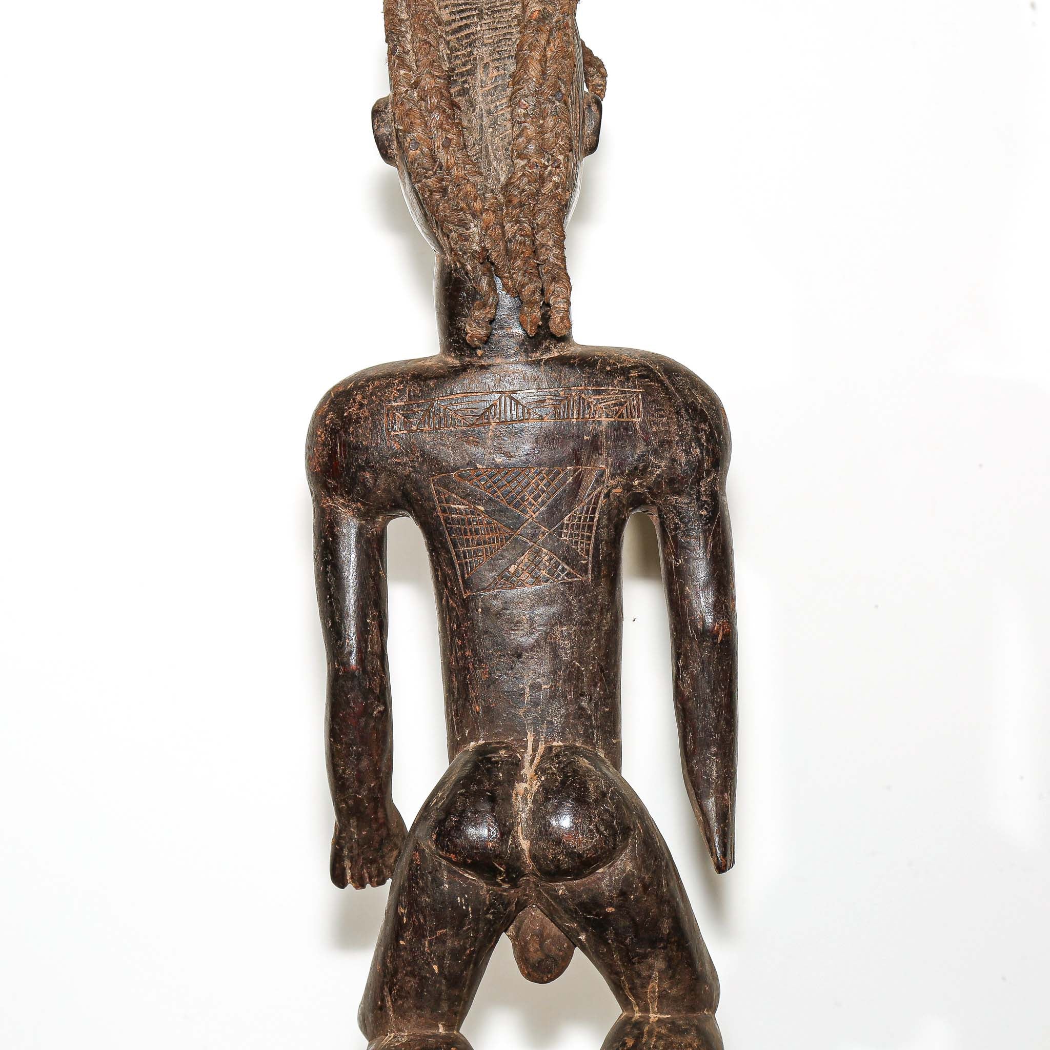 wooden male figure sculpture carved by the Dan people in Ivory Coast