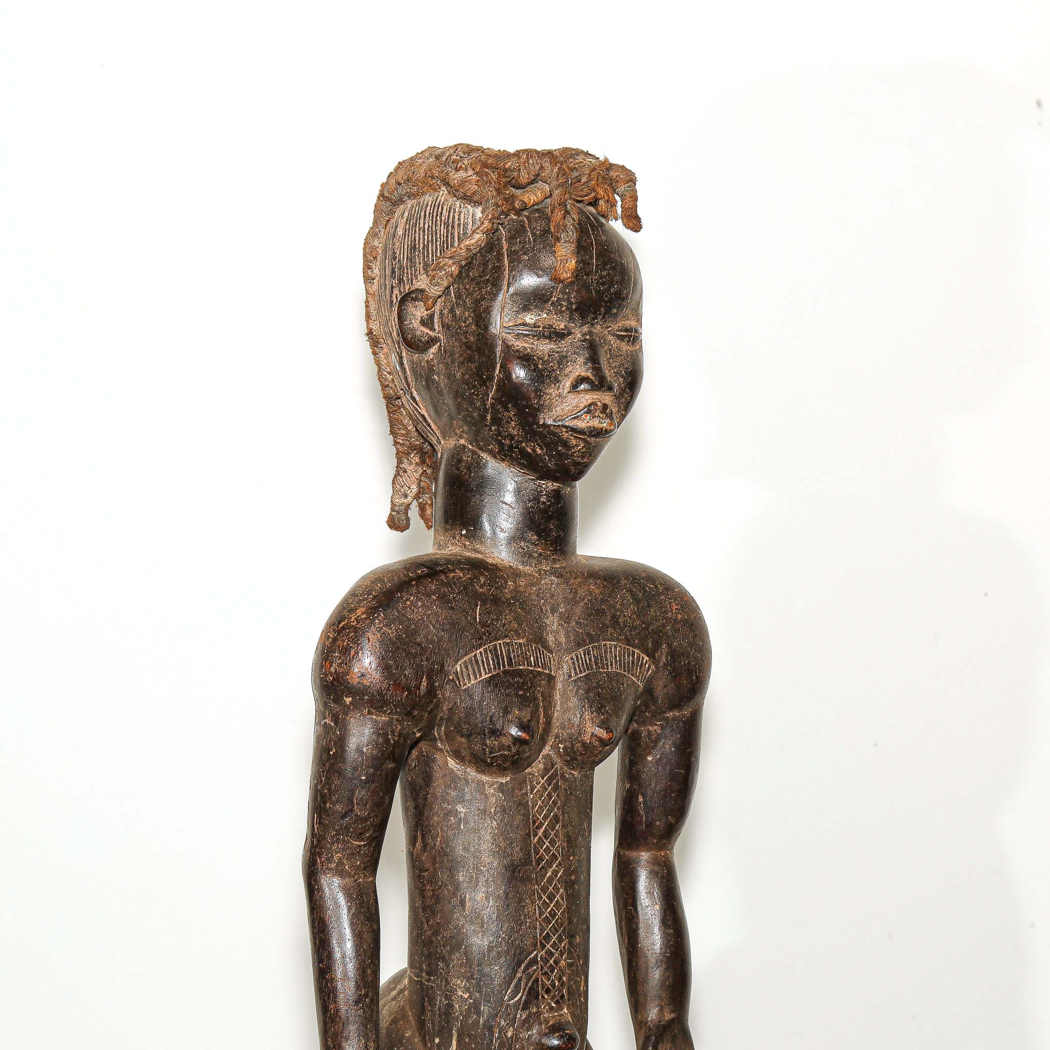 wooden male figure sculpture carved by the Dan people in Ivory Coast