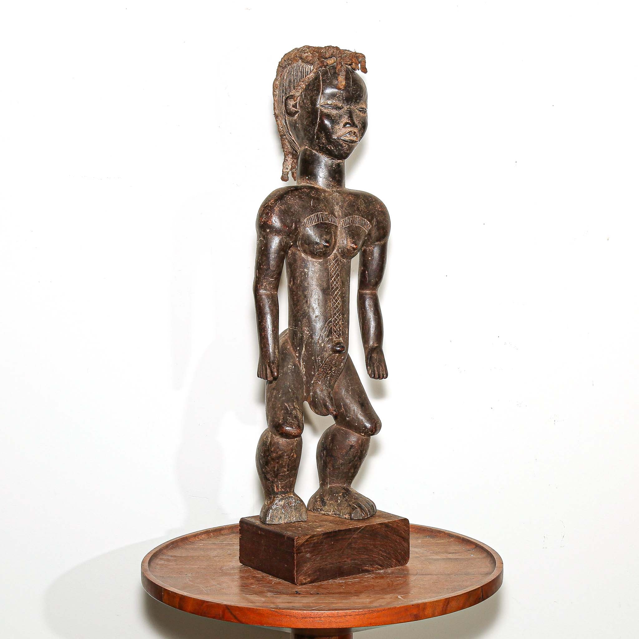 wooden male figure sculpture carved by the Dan people in Ivory Coast