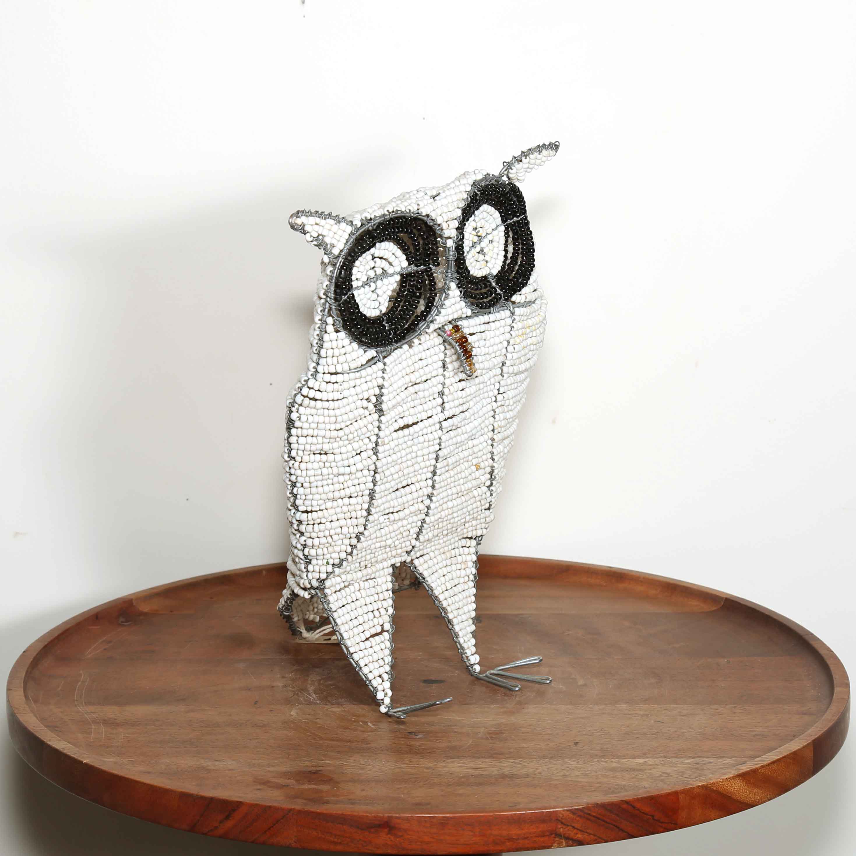 little white owl sculpture from Africa with black eyes made from glass beads