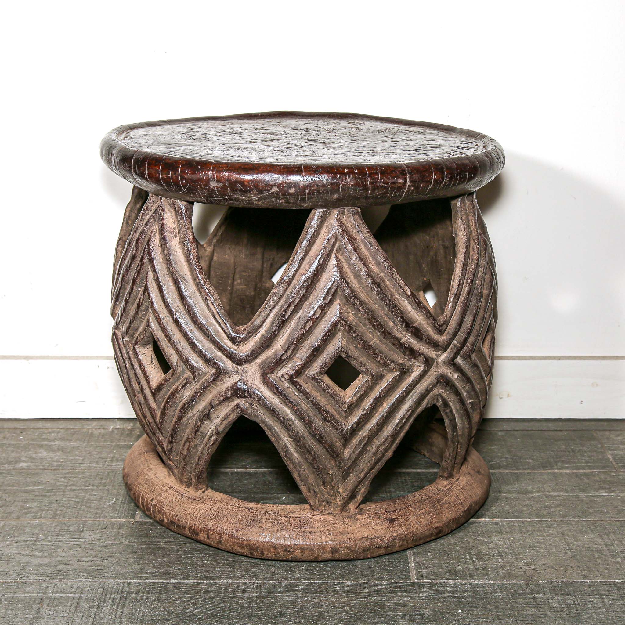 African style decor round table with geometric hand made pattern on a living room floor.