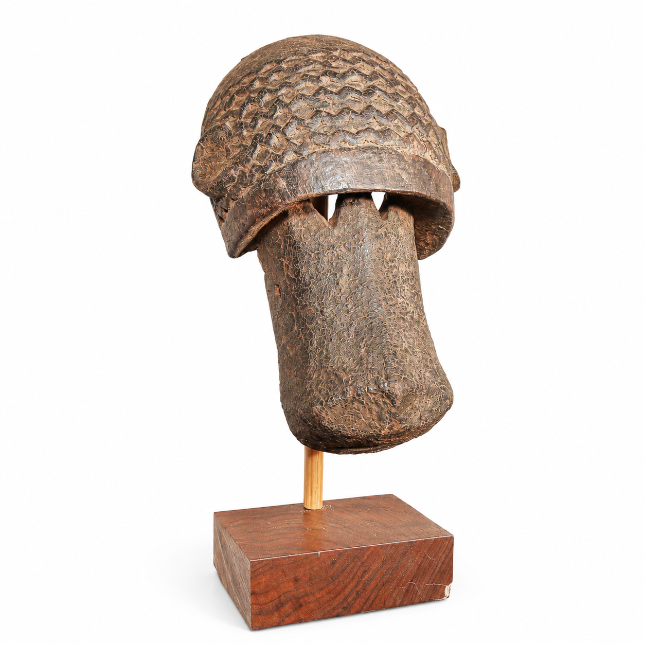 Authentic Tribal Dogon mask from Mali with a textured helmet on a wooden stand against a white background