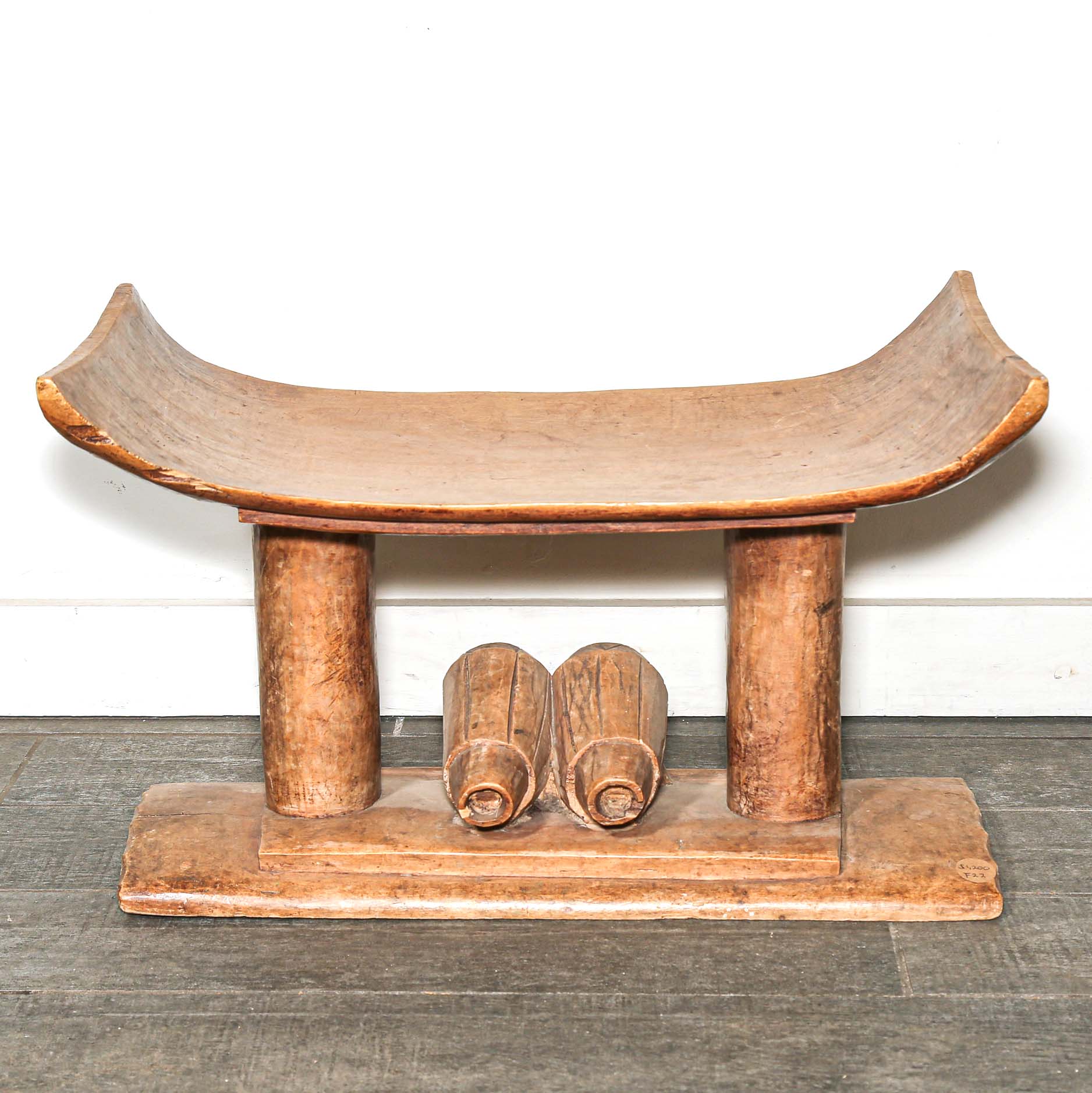 Vintage African furniture for sale. Authentic wooden stool on bed room floor