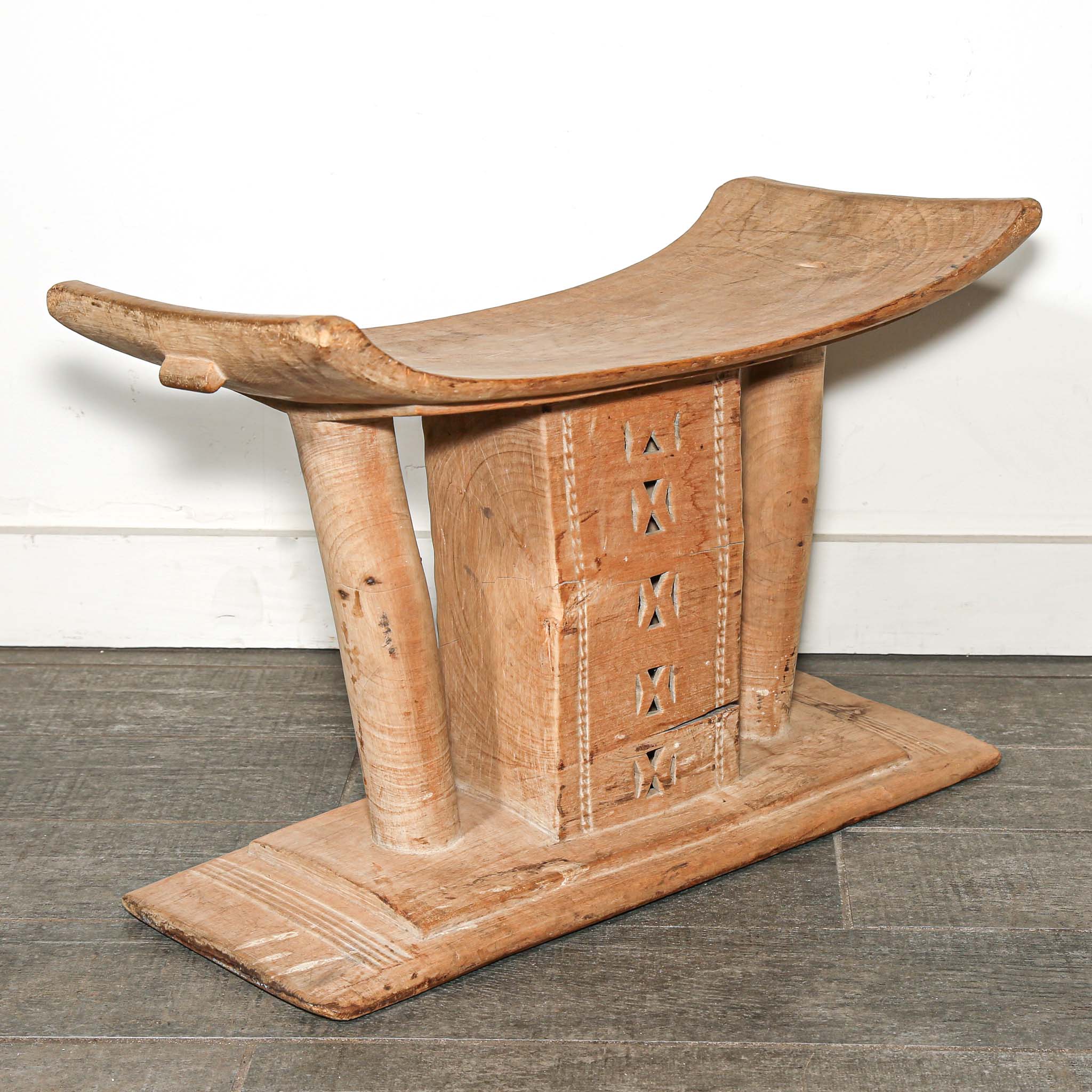 Vintage African furniture for sale. Authentic wooden stool on bed room floor