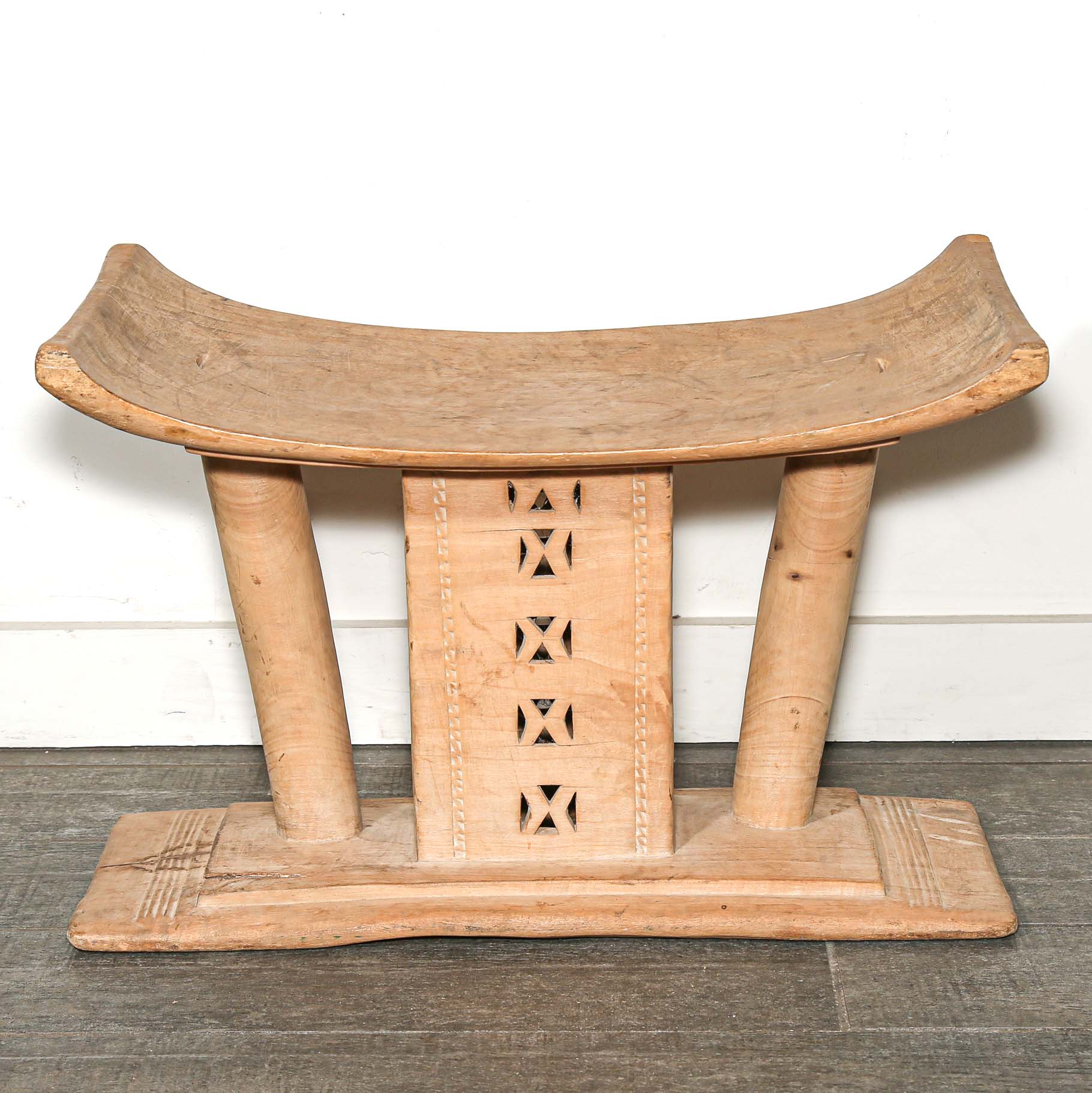 Vintage African furniture for sale. Authentic wooden stool on bed room floor