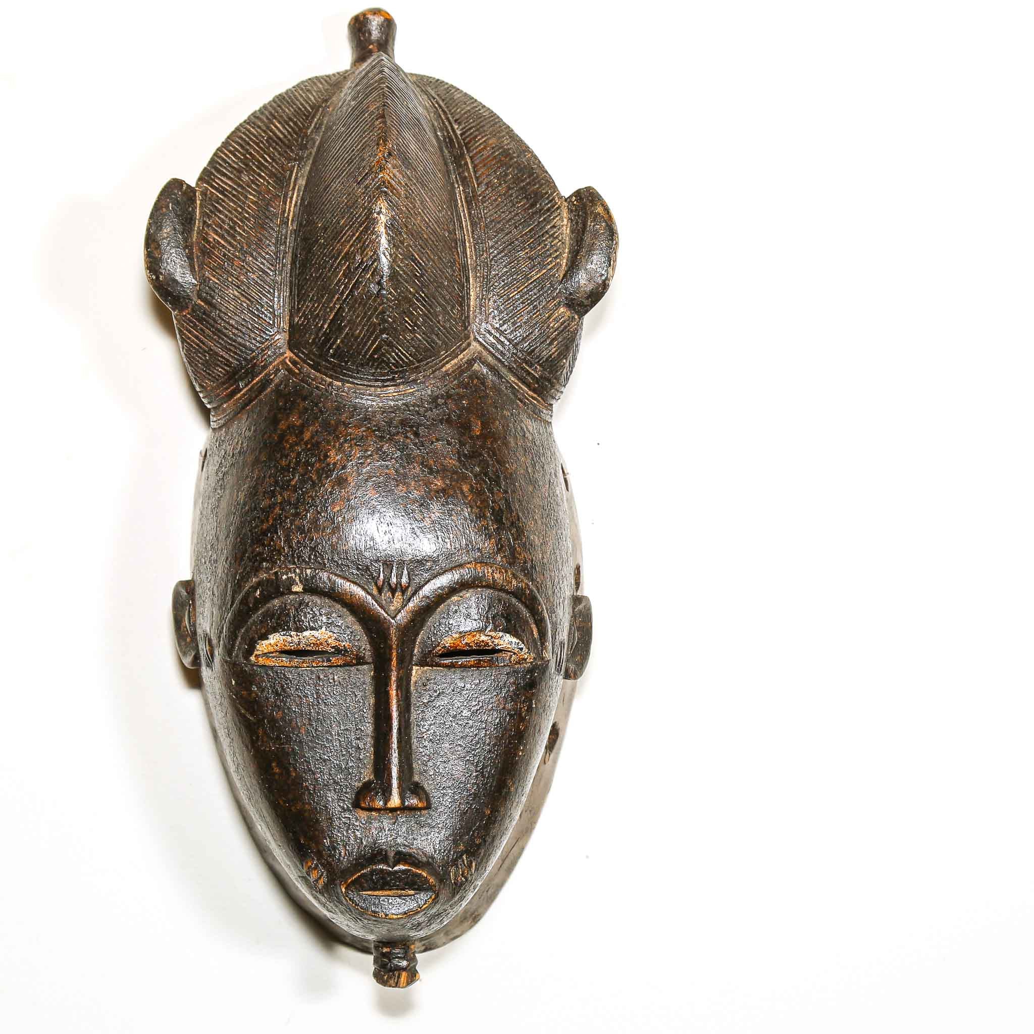 traditional African wooden mask on a white background