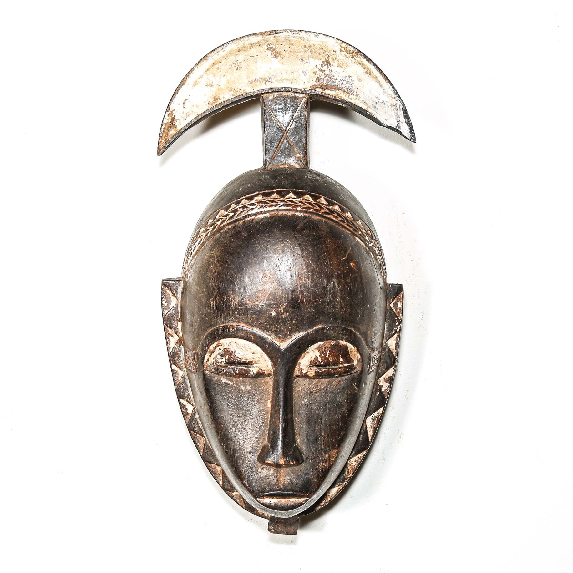 African-style silver mask on a white background