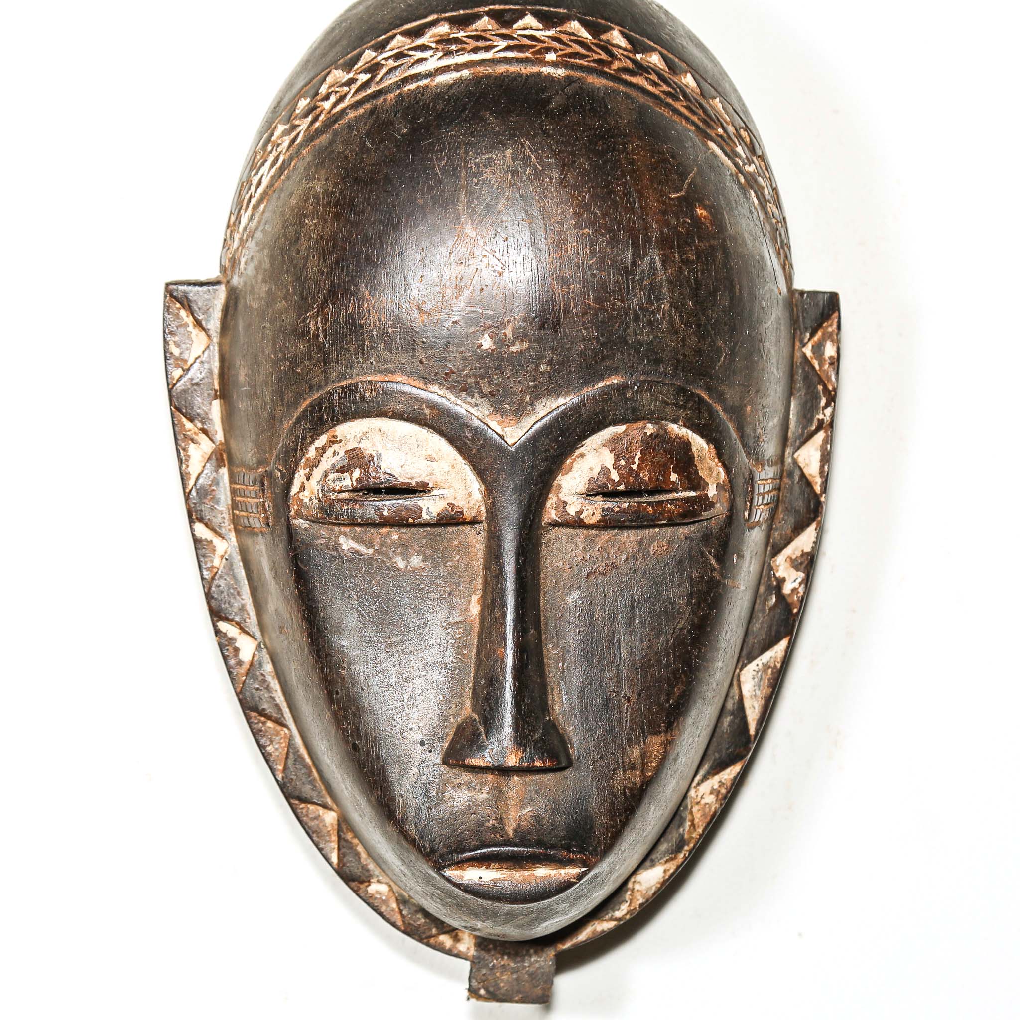 authentic tribal African mask with intricate designs on a white background