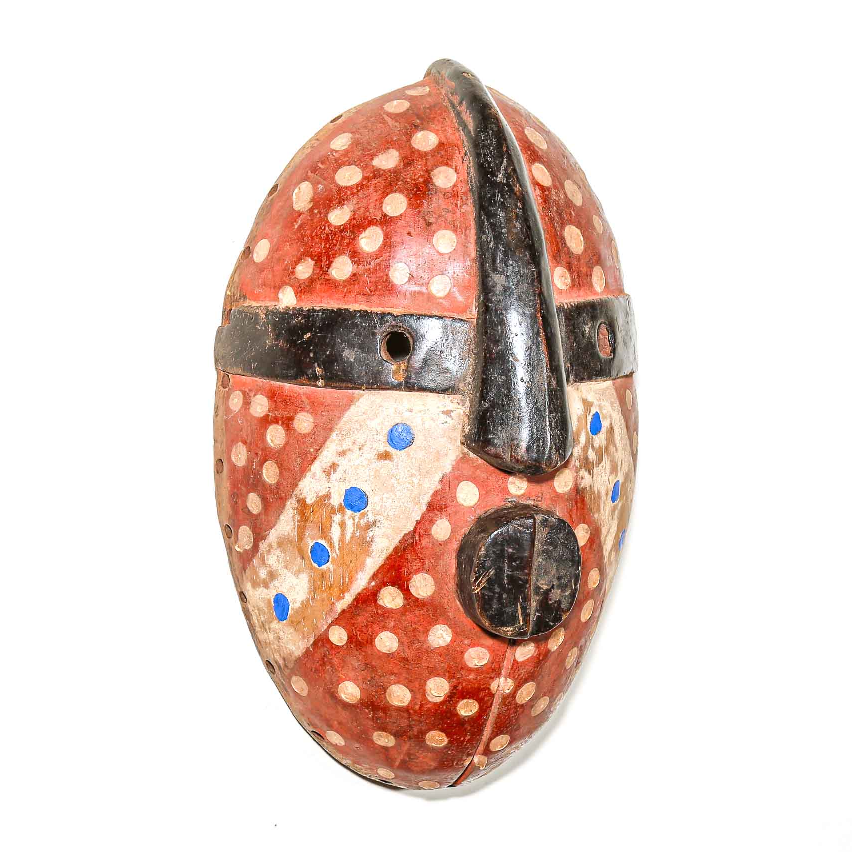 Decorative traditional African mask with polka dot pattern on a white background