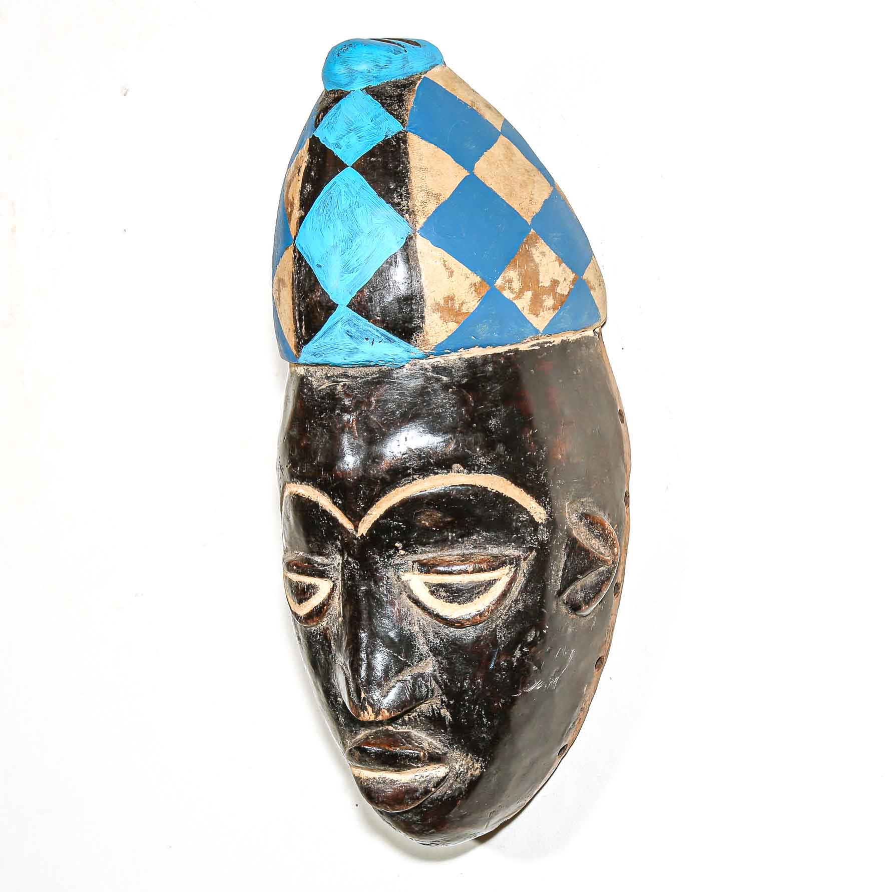 African mask with a checkered blue and beige headdress on a white background