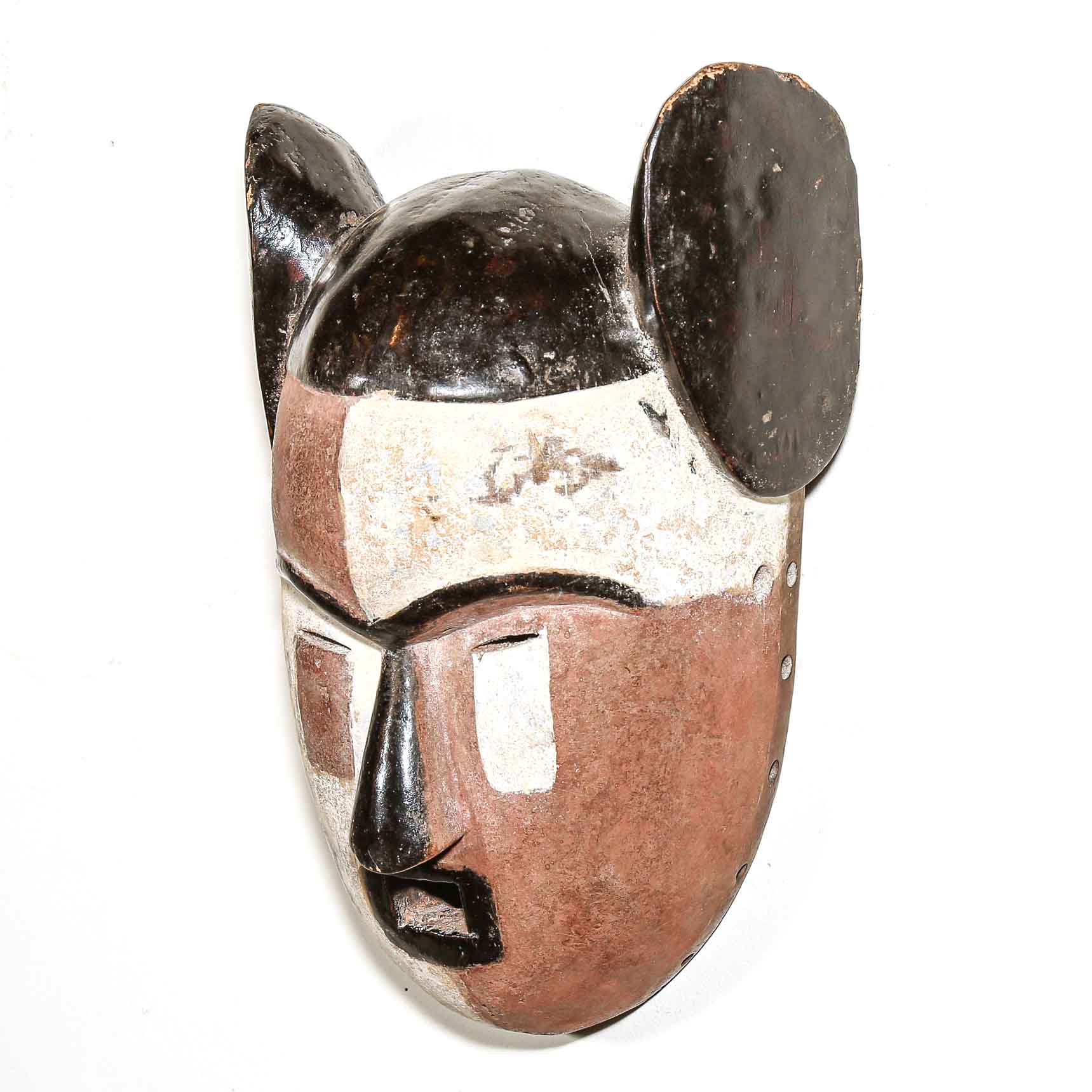wooden African mask with black and brown details on a white background