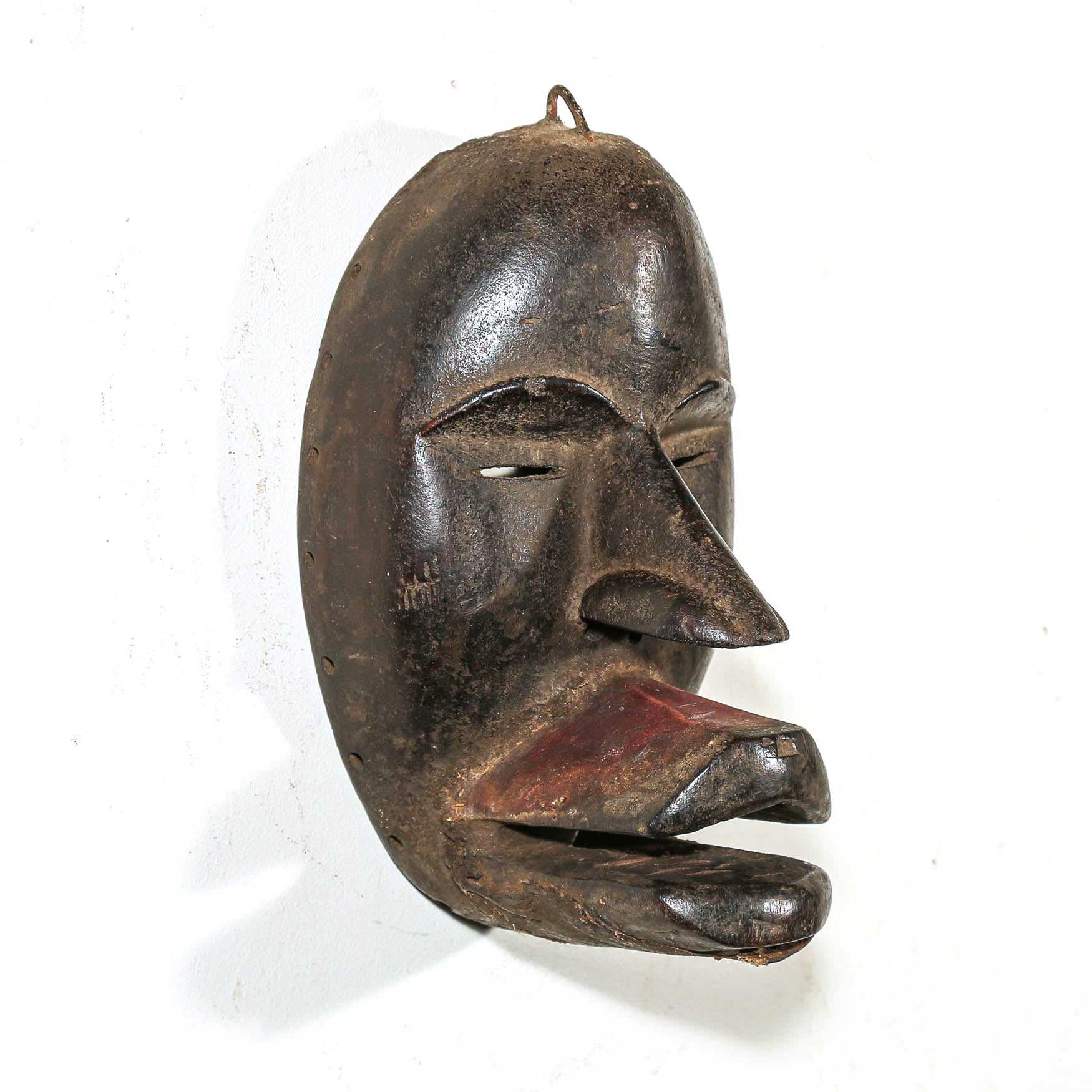 Black African Art tribal art hanging on a white living room wall