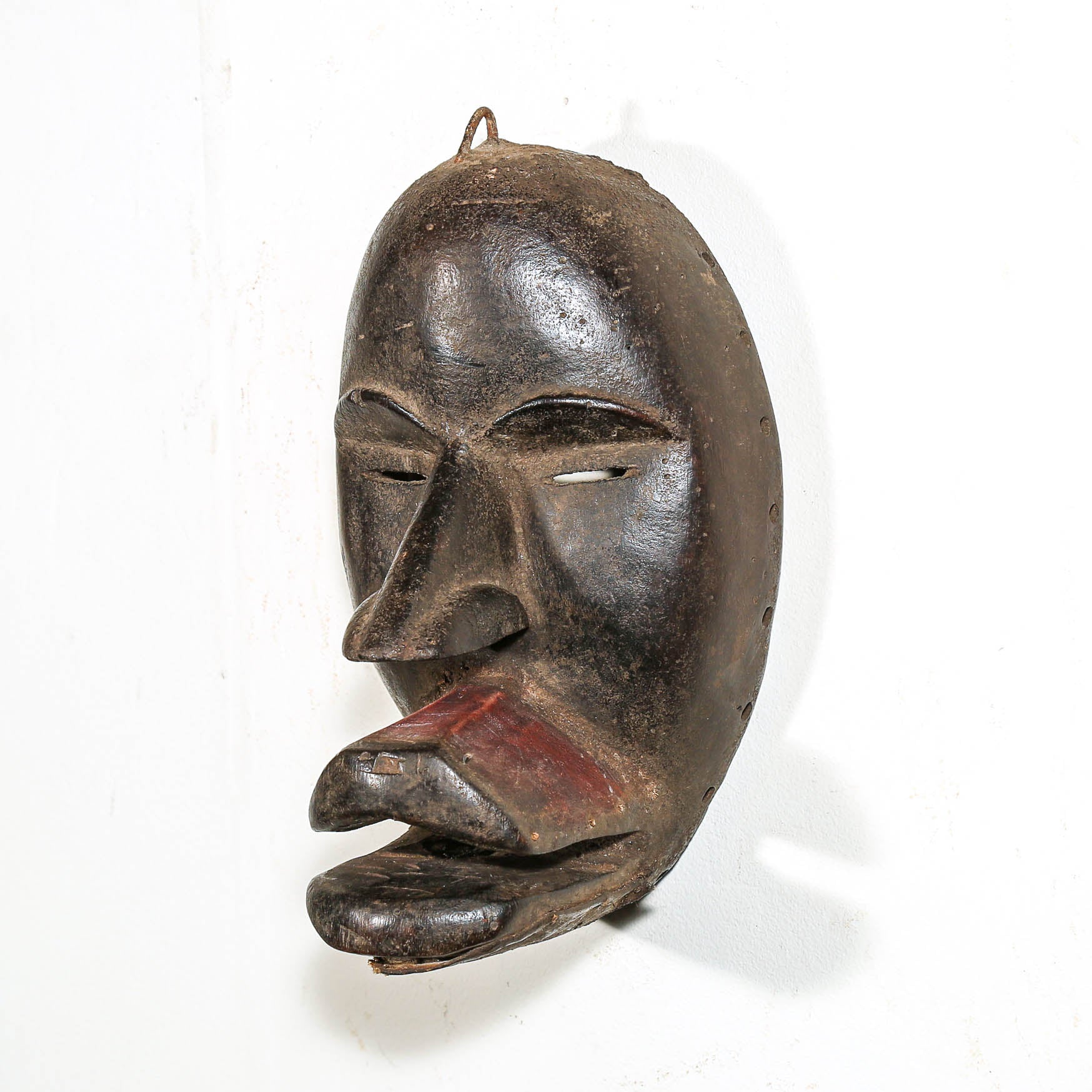 Black African Art tribal art hanging on a white living room wall