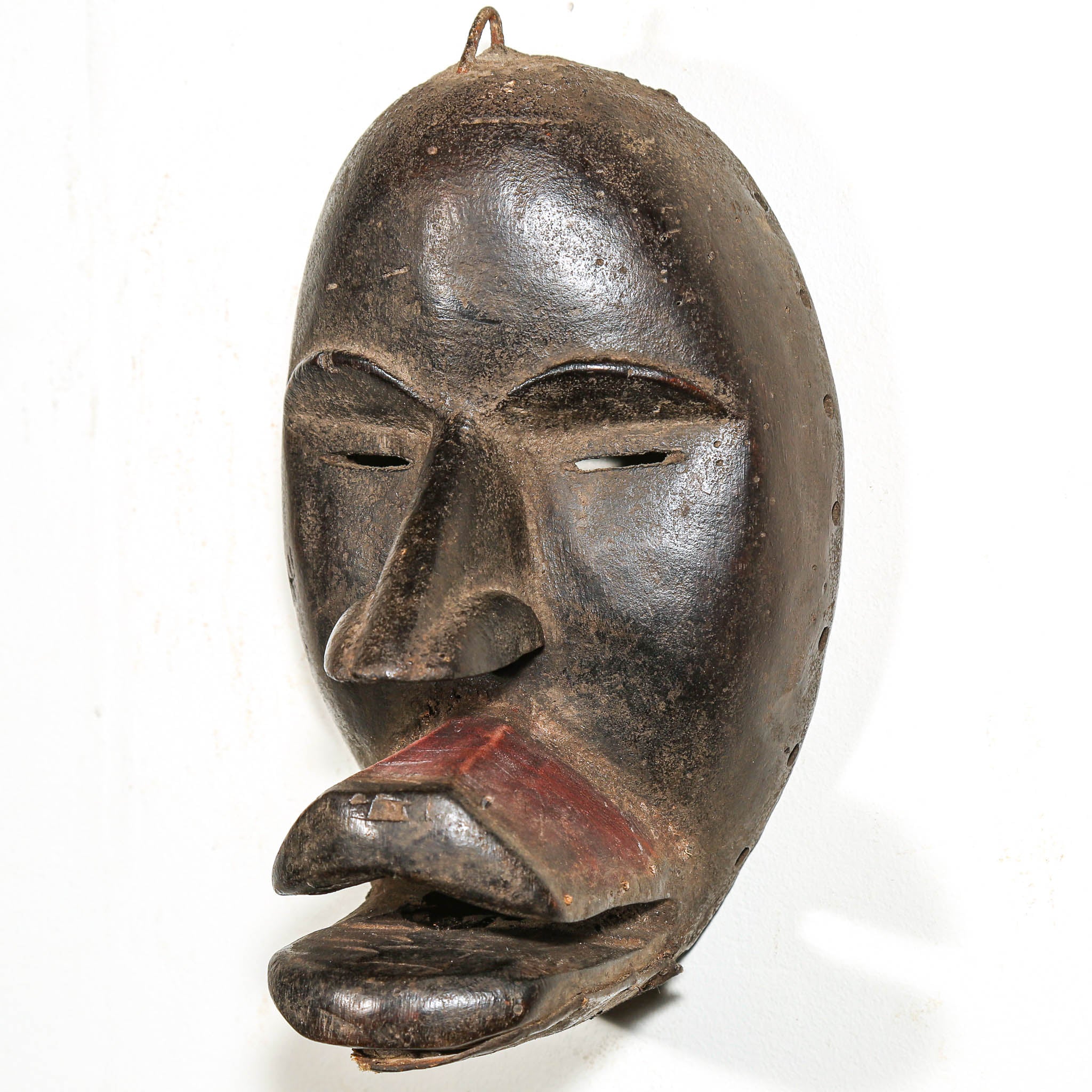 Black African Art tribal art hanging on a white living room wall