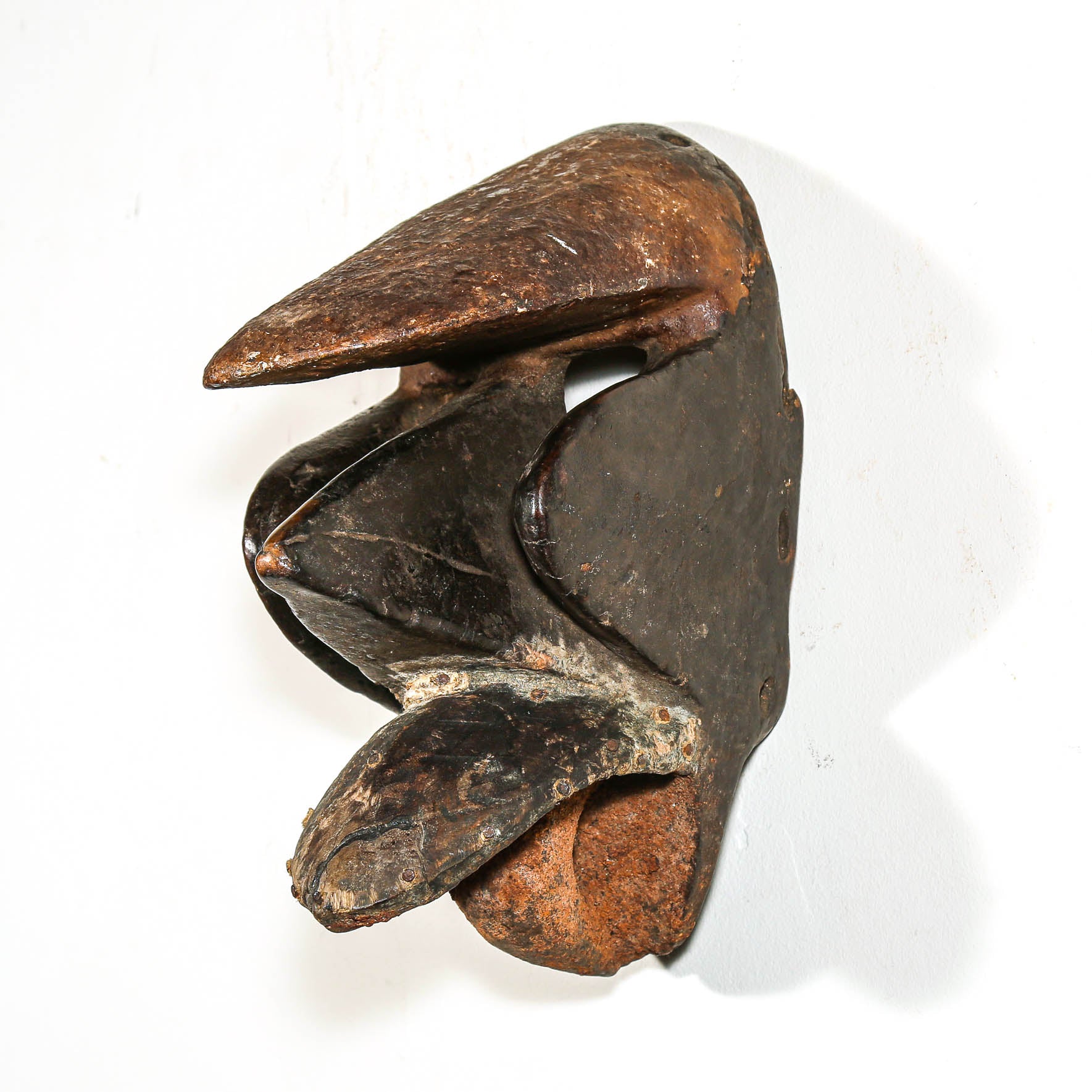 Black African art wood mask with a white collector's wall