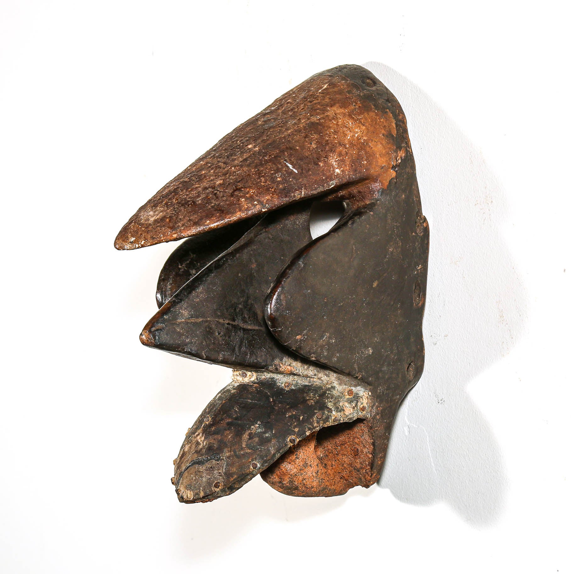 Black African art wood mask with a white collector's wall